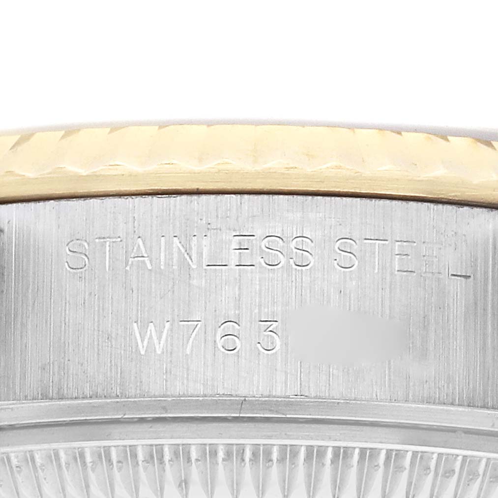 The image shows the side of a Rolex Datejust 69173 Women's Steel and Gold (two tone) Champagne Dial watch, focusing on the stainless steel part with engraved text.