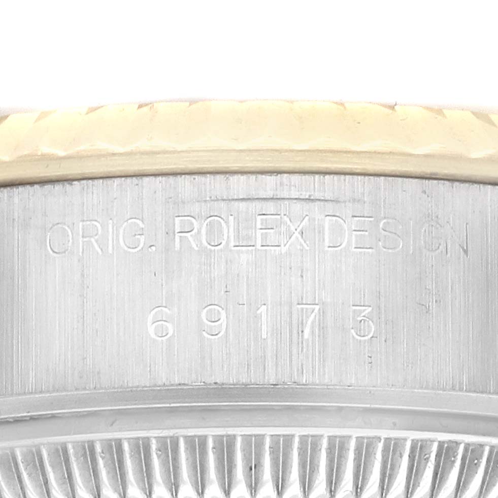 The image shows a close-up of the case side and bezel edge of a Rolex Datejust 69173 Women's Steel and Gold (two tone) Champagne Dial, highlighting the engraved model number.