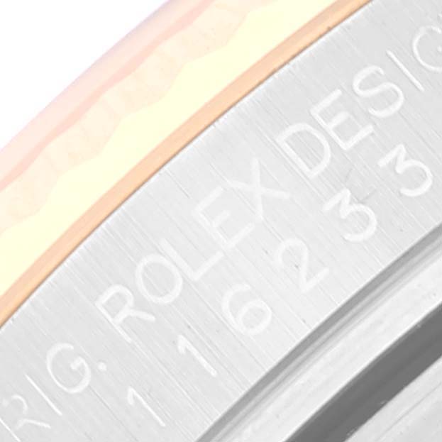 This image shows a close-up of the engraving on the case of a Rolex Datejust 116233 Men's Steel and Gold (two tone) White Dial 116233 Men's Steel and Gold (two tone) White Dial watch.