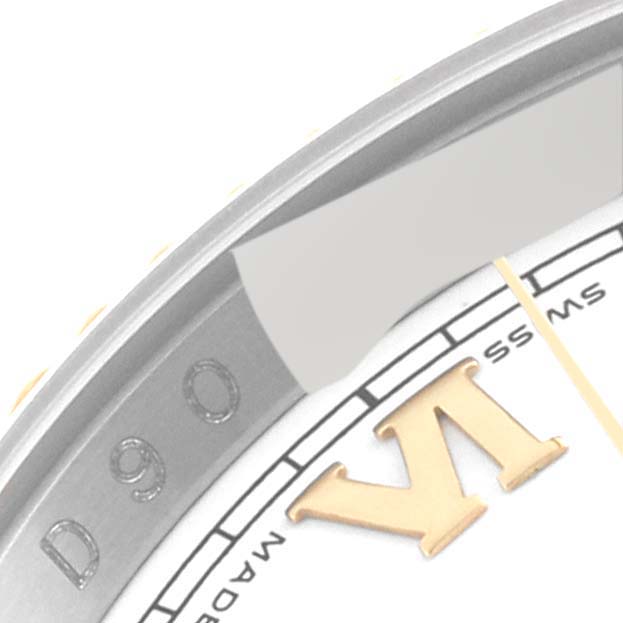 This close-up image shows the outer edge and part of the dial of a Rolex Datejust 116233 Men's Steel and Gold (two tone) White Dial 116233 Men's Steel and Gold (two tone) White Dial watch, including the Roman numeral hour marker "VI."