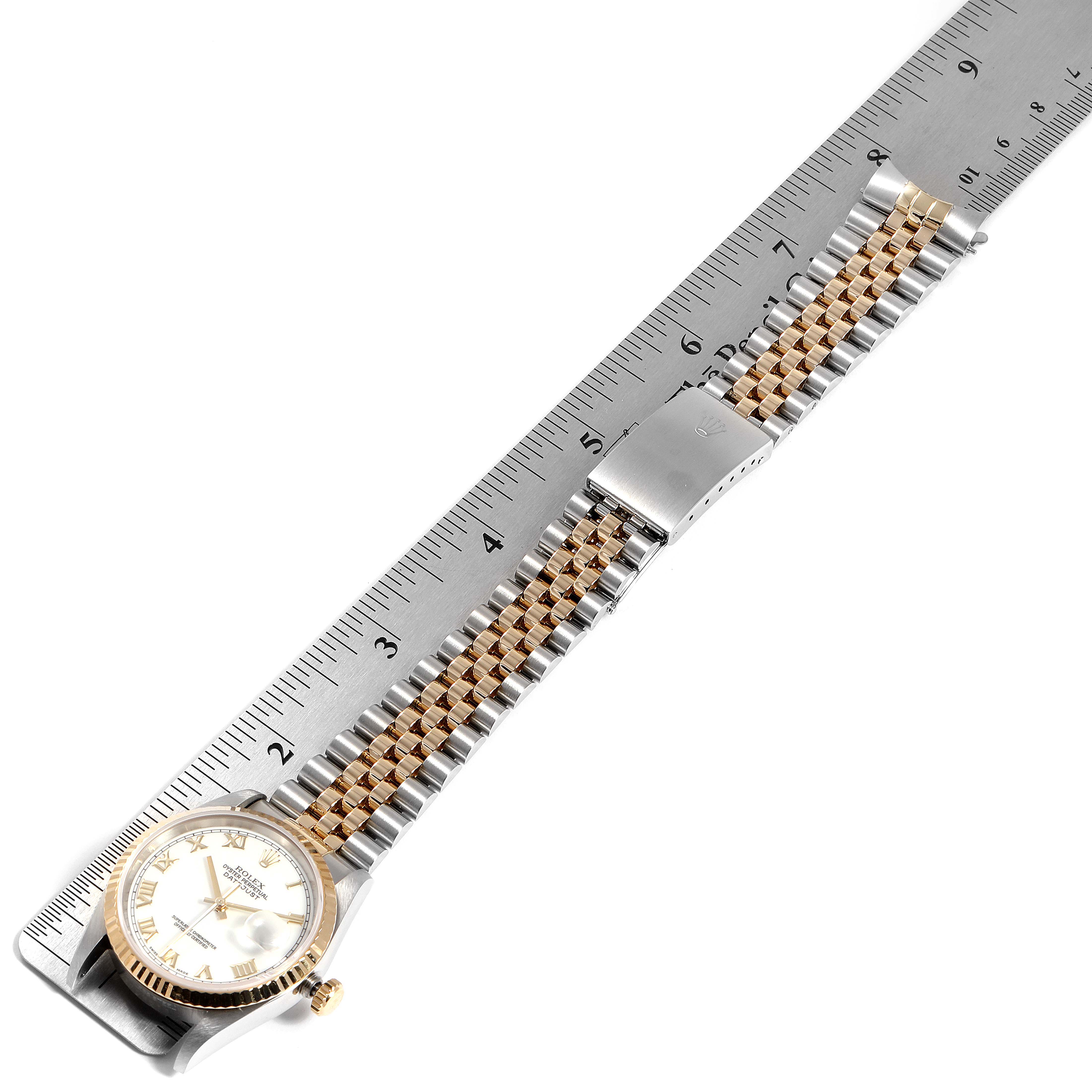 The image shows a Rolex Datejust 16233 Men
s Steel and Gold (two tone) White Dial 16233 Men
s Steel and Gold (two tone) White Dial watch from an overhead angle, displaying the watch face, bezel, and bracelet with a measuring scale.