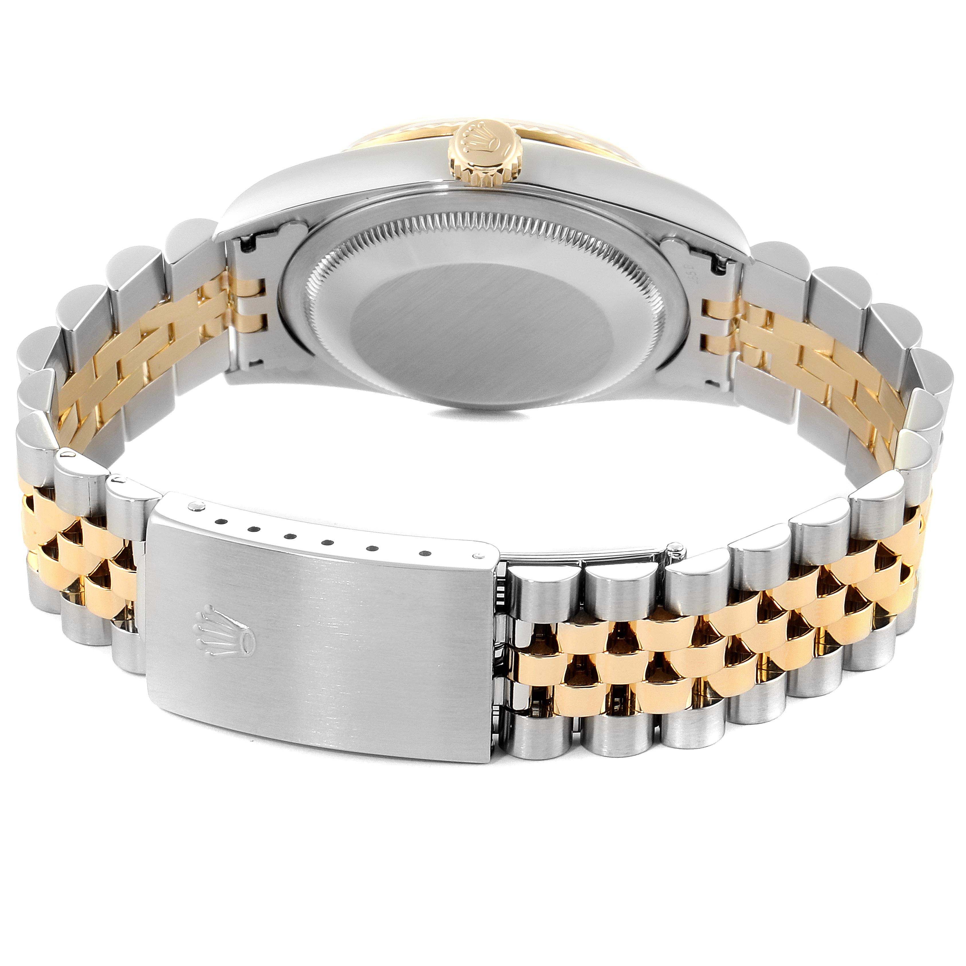 The image shows the backside and clasp of a Rolex Datejust 16233 Men
s Steel and Gold (two tone) White Dial 16233 Men
s Steel and Gold (two tone) White Dial watch, highlighting its two-tone bracelet and caseback.