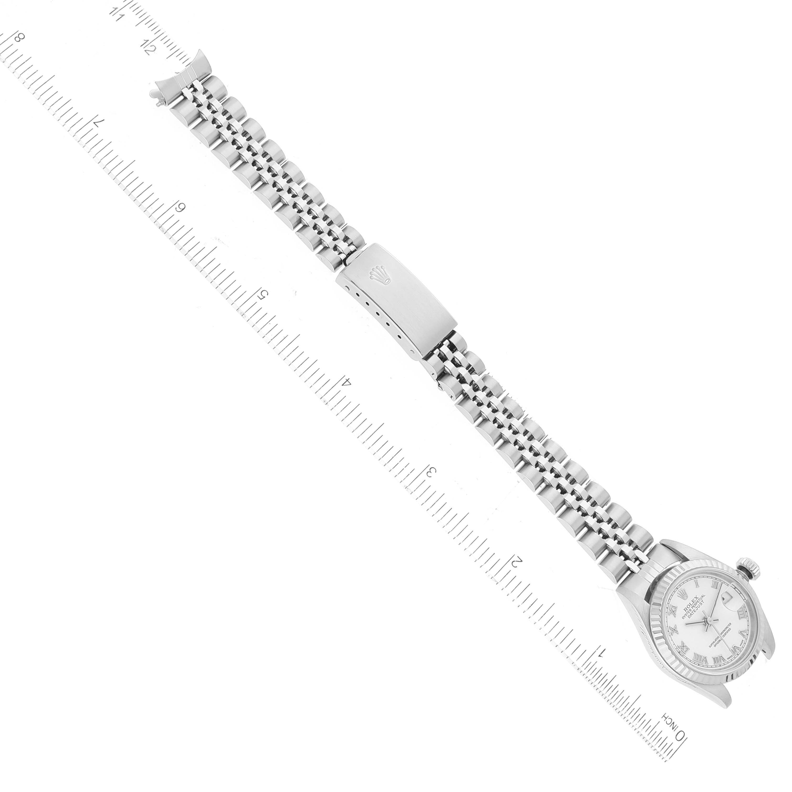 The image shows a Rolex Datejust 79174 Women's Stainless Steel White Dial 79174 Women's Stainless Steel White Dial watch with a ruler next to it, highlighting the full length of the watch including the face and bracelet.