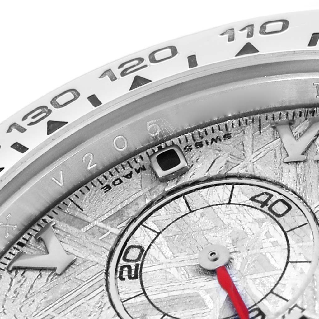 The image shows a close-up of a Rolex Daytona 116519 Men
s White Gold Silver Dial, highlighting the bezel, dial, and part of the subdial.