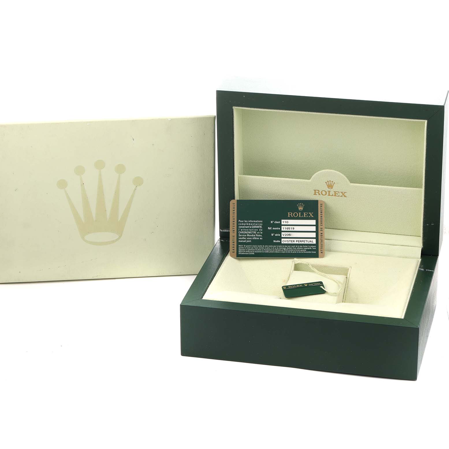 The image shows a Rolex Daytona 116519 Men
s White Gold Silver Dial watch box with the outer box, warranty card, and tag inside.