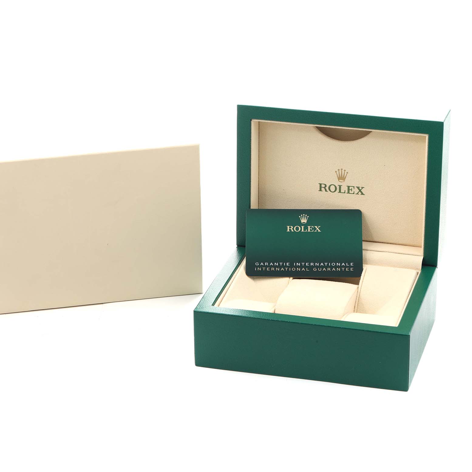 The image shows a green Rolex box for an Explorer model, featuring a guarantee card and padded watch holder.