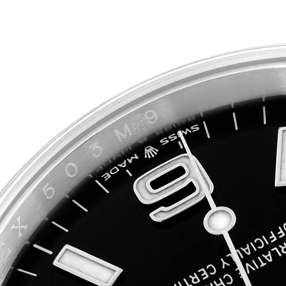 The image shows a close-up of the dial of the Rolex Explorer 124270 Men
s Stainless Steel Black Dial, highlighting the number 9, minute markers, and partially visible text.