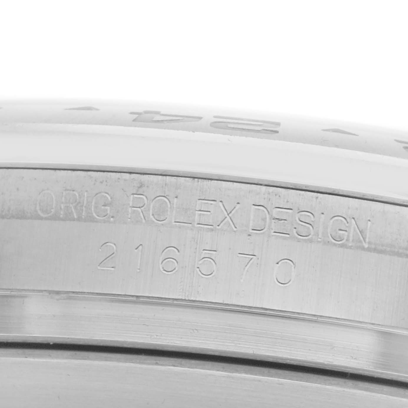 The image shows a close-up of the Rolex Explorer 216570 Men
s Stainless Steel Black Dial
s case edge with engraved text and model number.