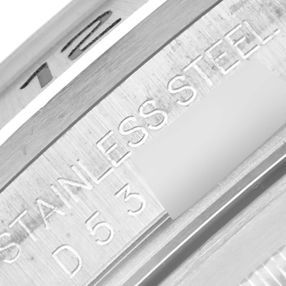 This close-up image shows the inner bezel of a Rolex Explorer 16570 Men's Stainless Steel White Dial 16570 Men's Stainless Steel White Dial watch with the engraved text "STAINLESS STEEL" and partial serial number.