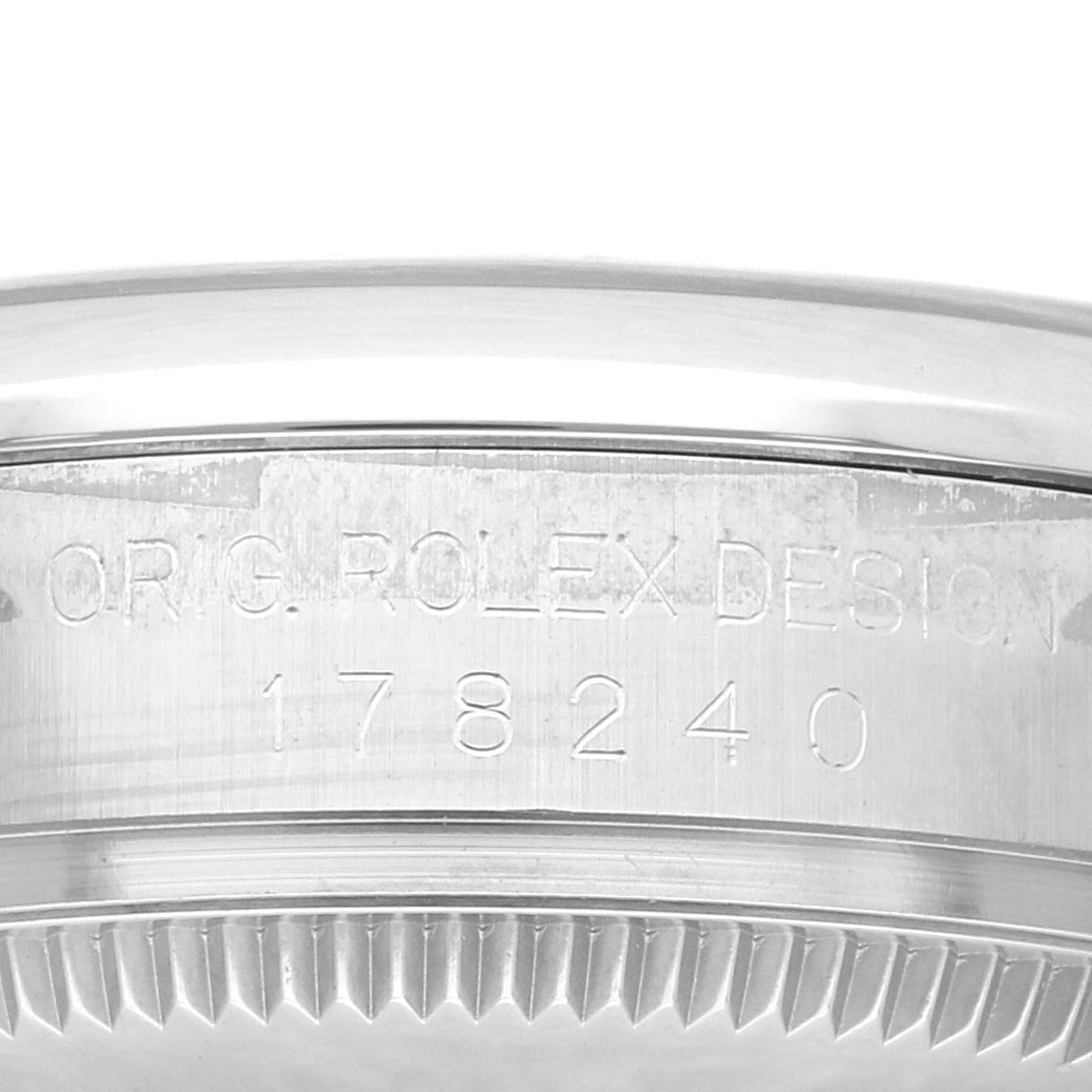 This image shows a close-up of the case back edge of a Rolex Mid-Size 178240 Women's Stainless Steel Pink Dial 178240 Women's Stainless Steel Pink Dial model, highlighting its engraved details.