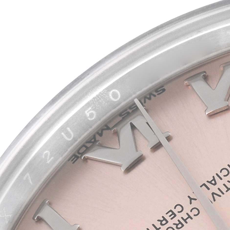 The image shows a partial close-up of a pink dial and silver bezel with Roman numerals on a Rolex Mid-Size 178240 Women's Stainless Steel Pink Dial 178240 Women's Stainless Steel Pink Dial watch.