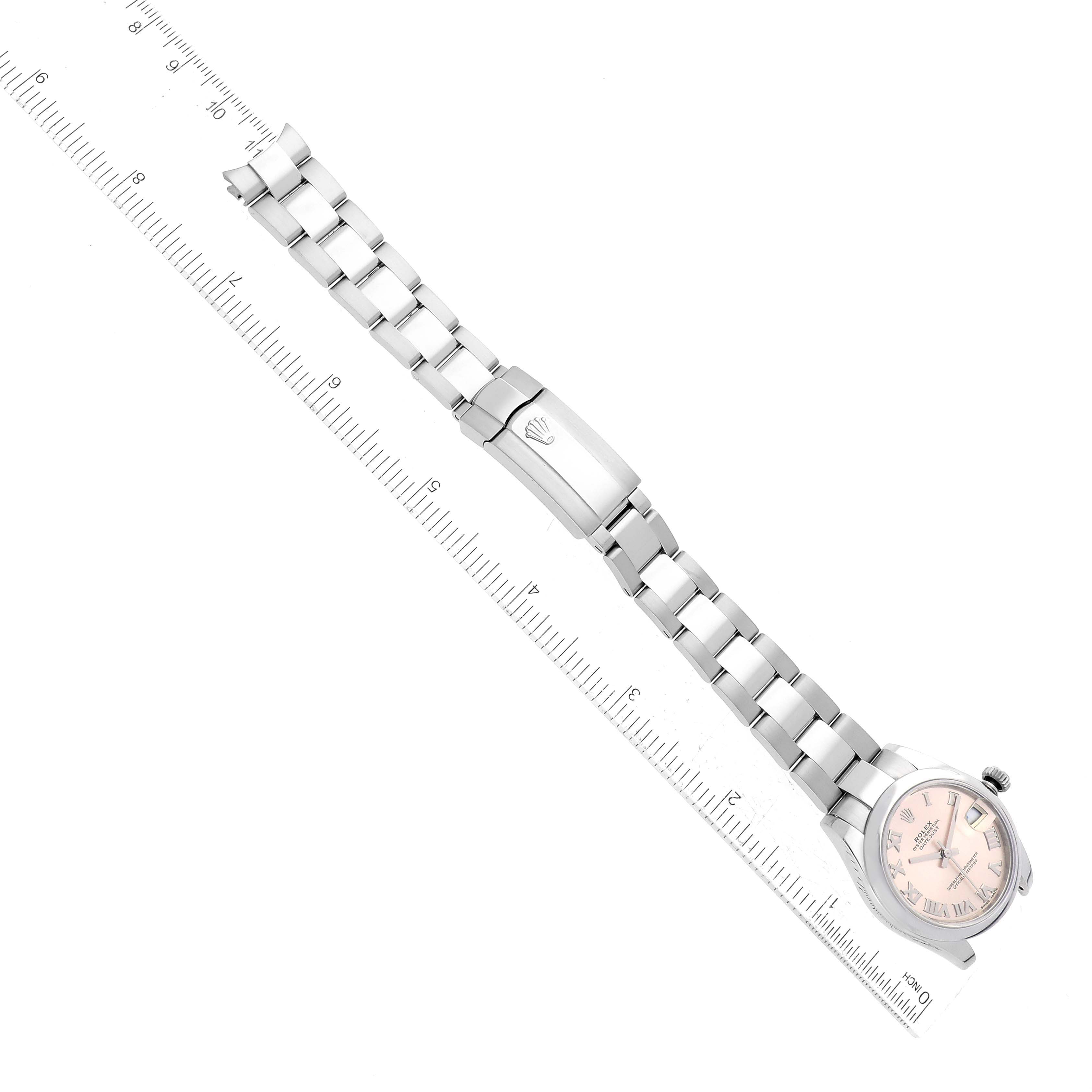 The image shows a Rolex Mid-Size 178240 Women's Stainless Steel Pink Dial 178240 Women's Stainless Steel Pink Dial watch laid flat with its metal bracelet stretched alongside a measuring ruler.