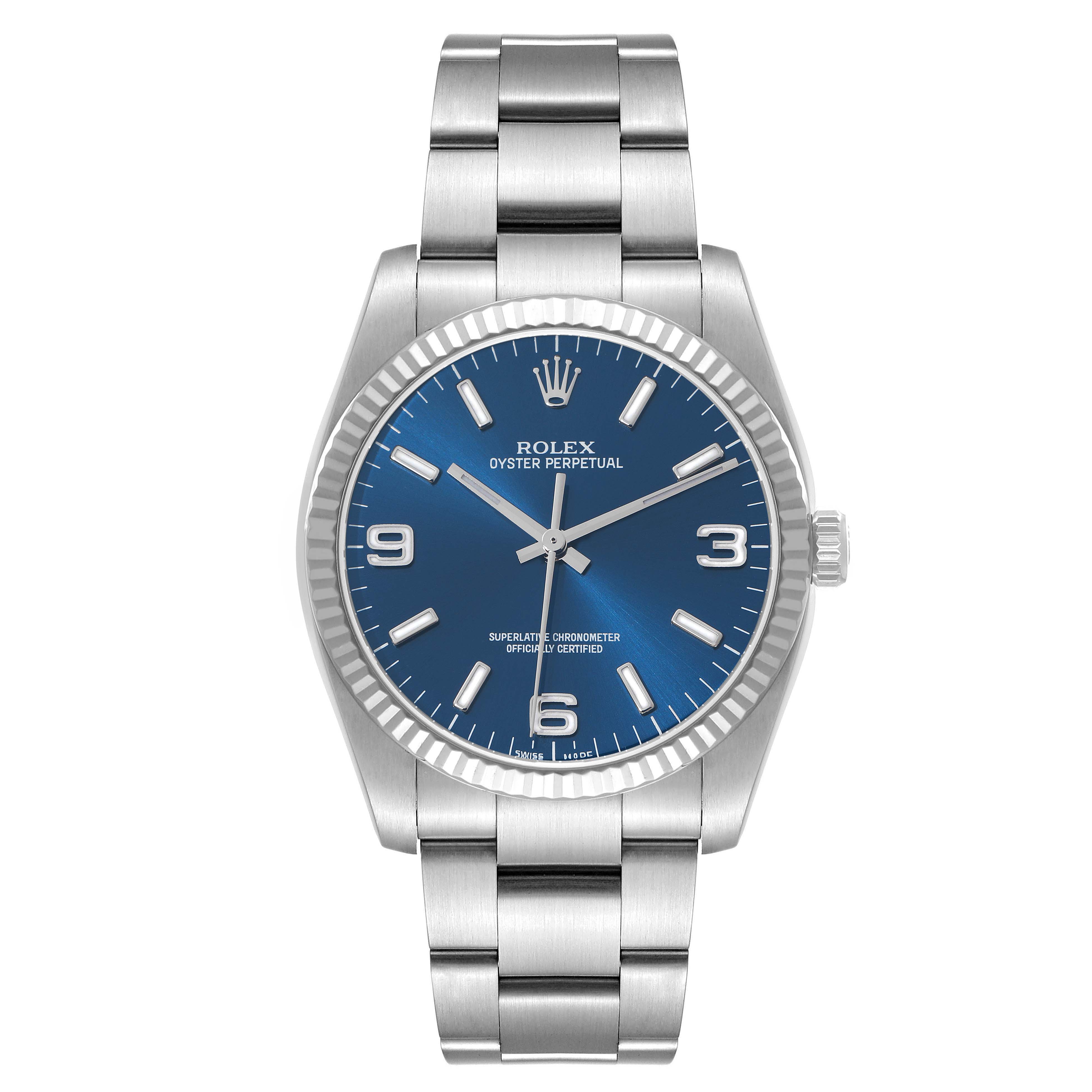 The Rolex Oyster Perpetual 116034 Men's Stainless Steel Blue Dial watch is shown from a top-down angle, displaying the blue dial, markers, case, and bracelet.