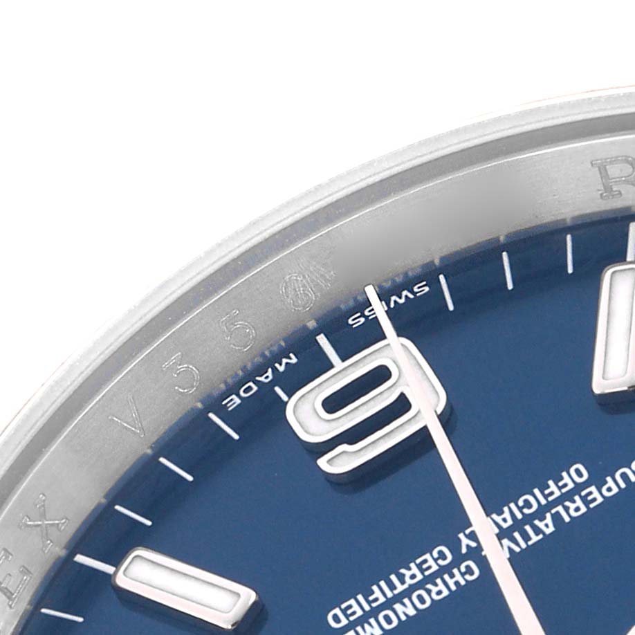 The image shows a close-up of the Rolex Oyster Perpetual 116034 Men's Stainless Steel Blue Dial's blue dial, featuring the 9 o'clock marker and parts of the bezel.