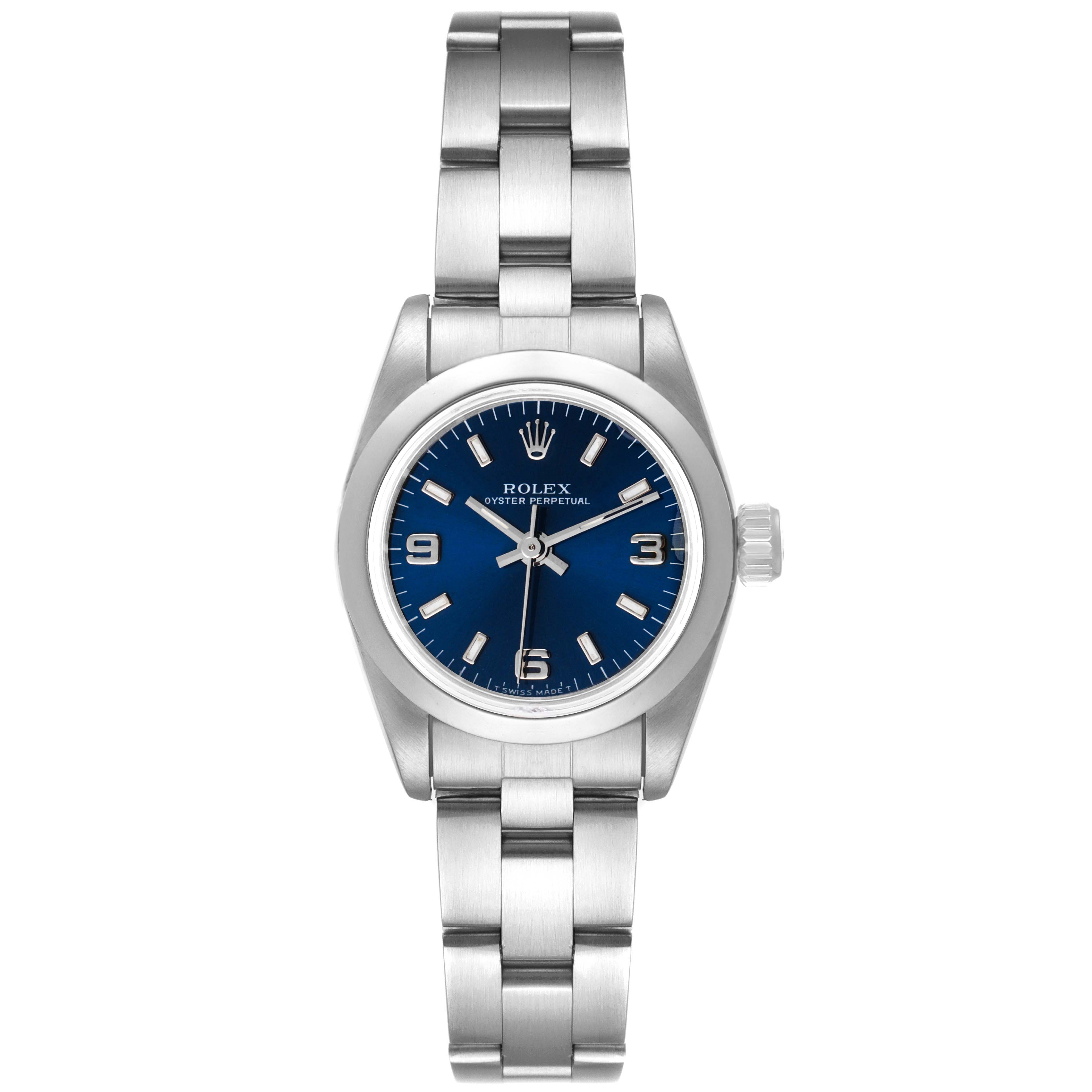 The image shows a Rolex Oyster Perpetual 67180 Women's Stainless Steel Blue Dial 67180 Women's Stainless Steel Blue Dial watch from a top-down angle, highlighting the face, bezel, crown, and stainless steel bracelet.
