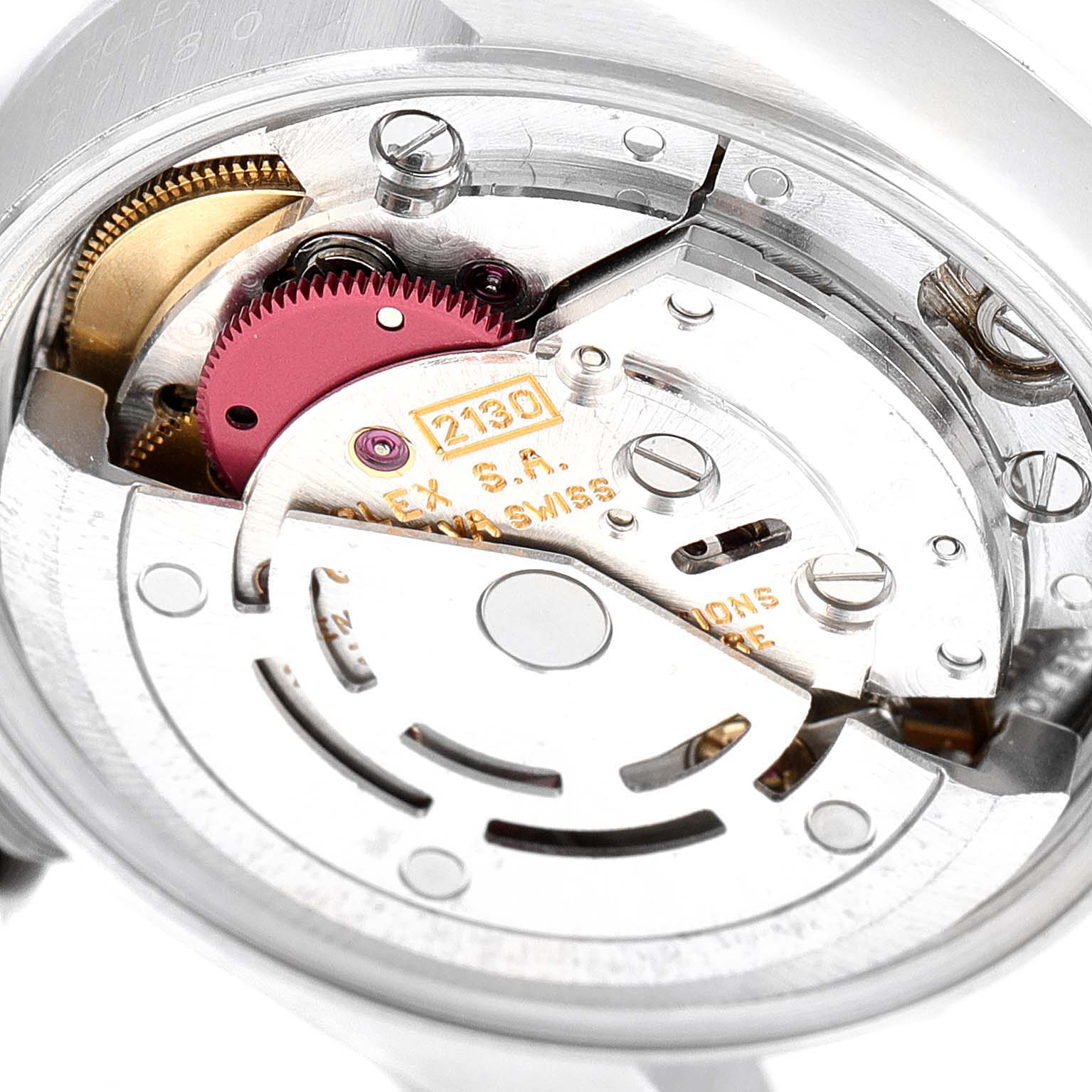 This image shows a close-up of the internal movement mechanism of a Rolex Oyster Perpetual 67180 Women's Stainless Steel Blue Dial 67180 Women's Stainless Steel Blue Dial watch, featuring gears and other components.