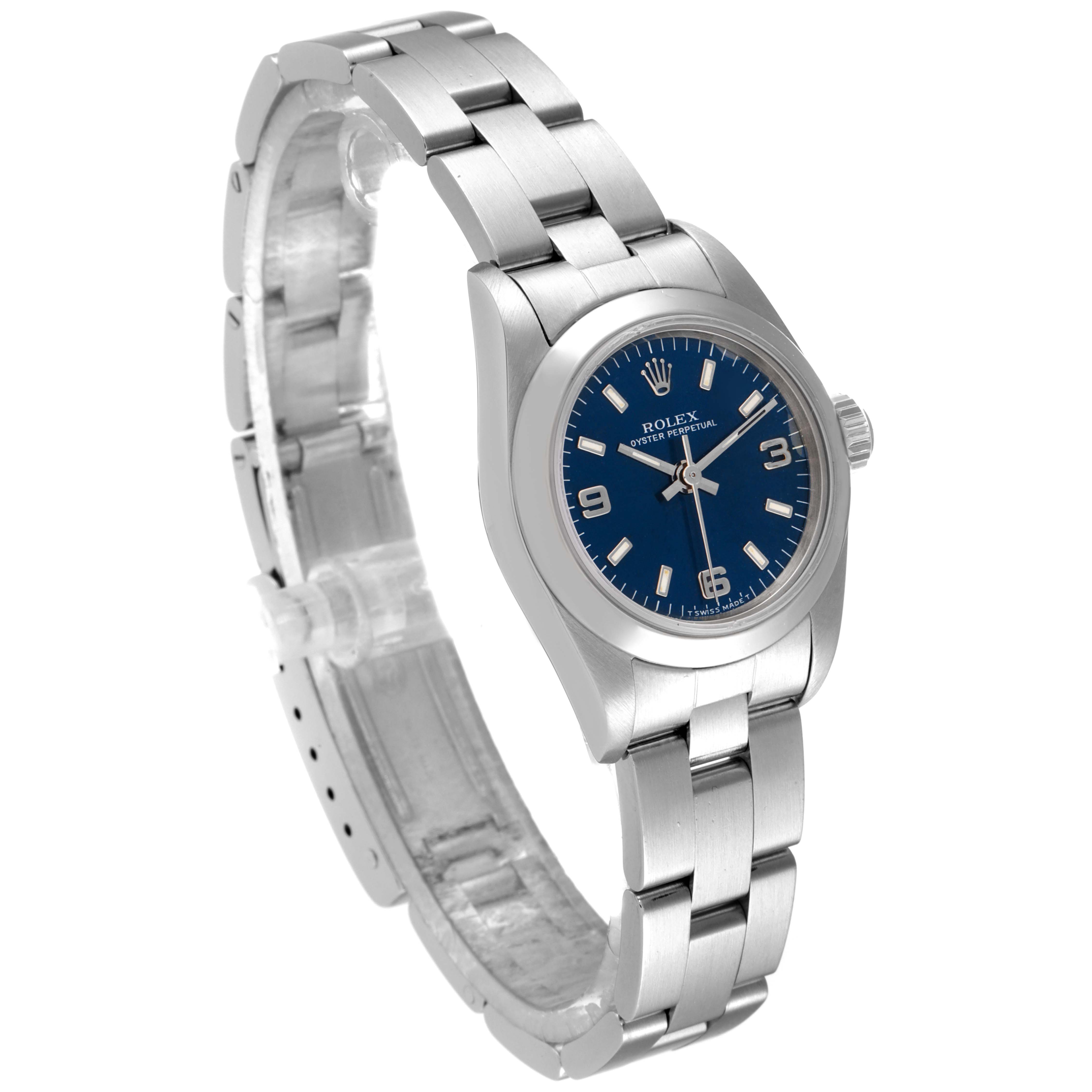 The image shows a three-quarter view of a Rolex Oyster Perpetual 67180 Women's Stainless Steel Blue Dial 67180 Women's Stainless Steel Blue Dial watch, featuring the case, dial, crown, and bracelet.