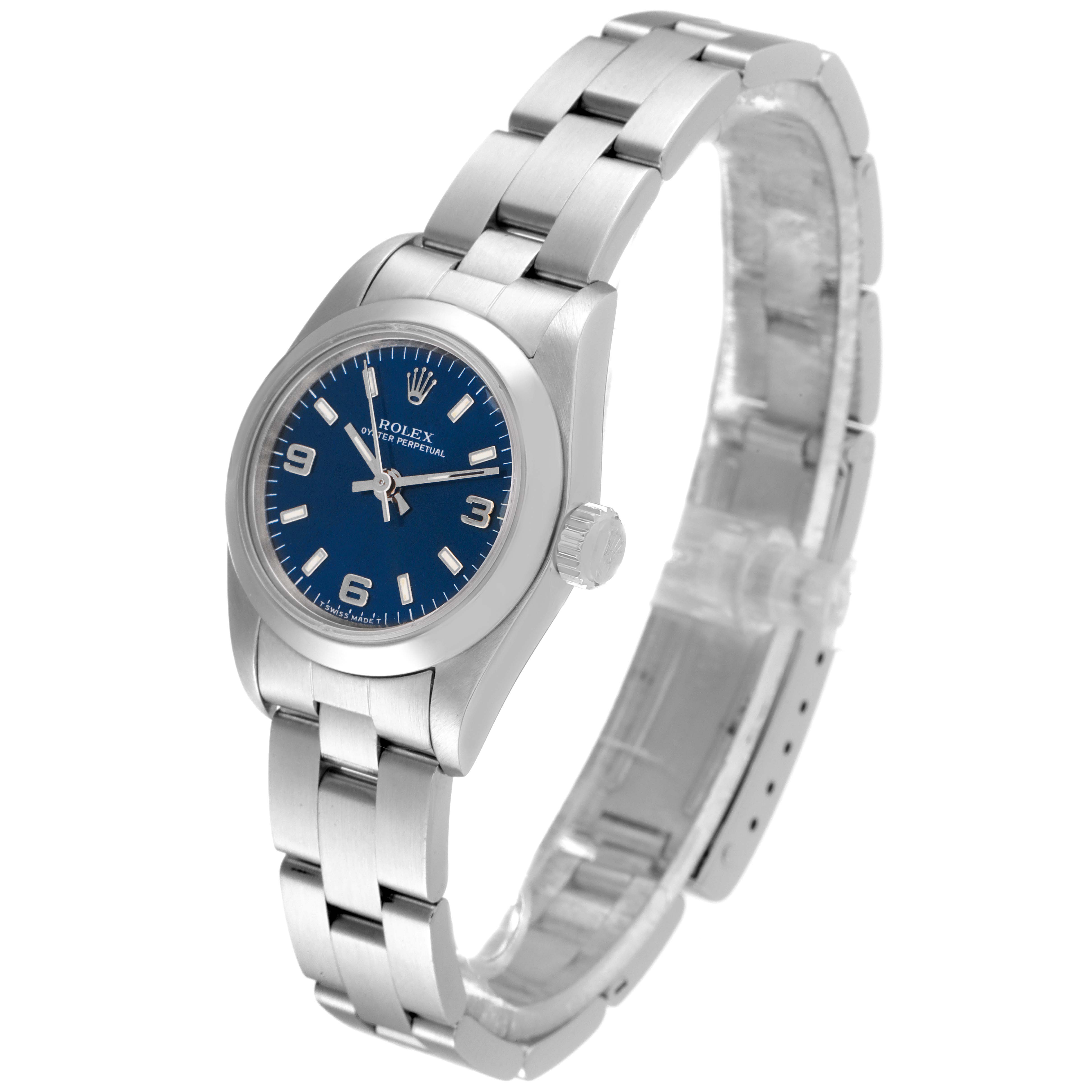 The Rolex Oyster Perpetual 67180 Women's Stainless Steel Blue Dial 67180 Women's Stainless Steel Blue Dial watch is pictured at an angle showcasing its blue dial, crown, and stainless steel bracelet.
