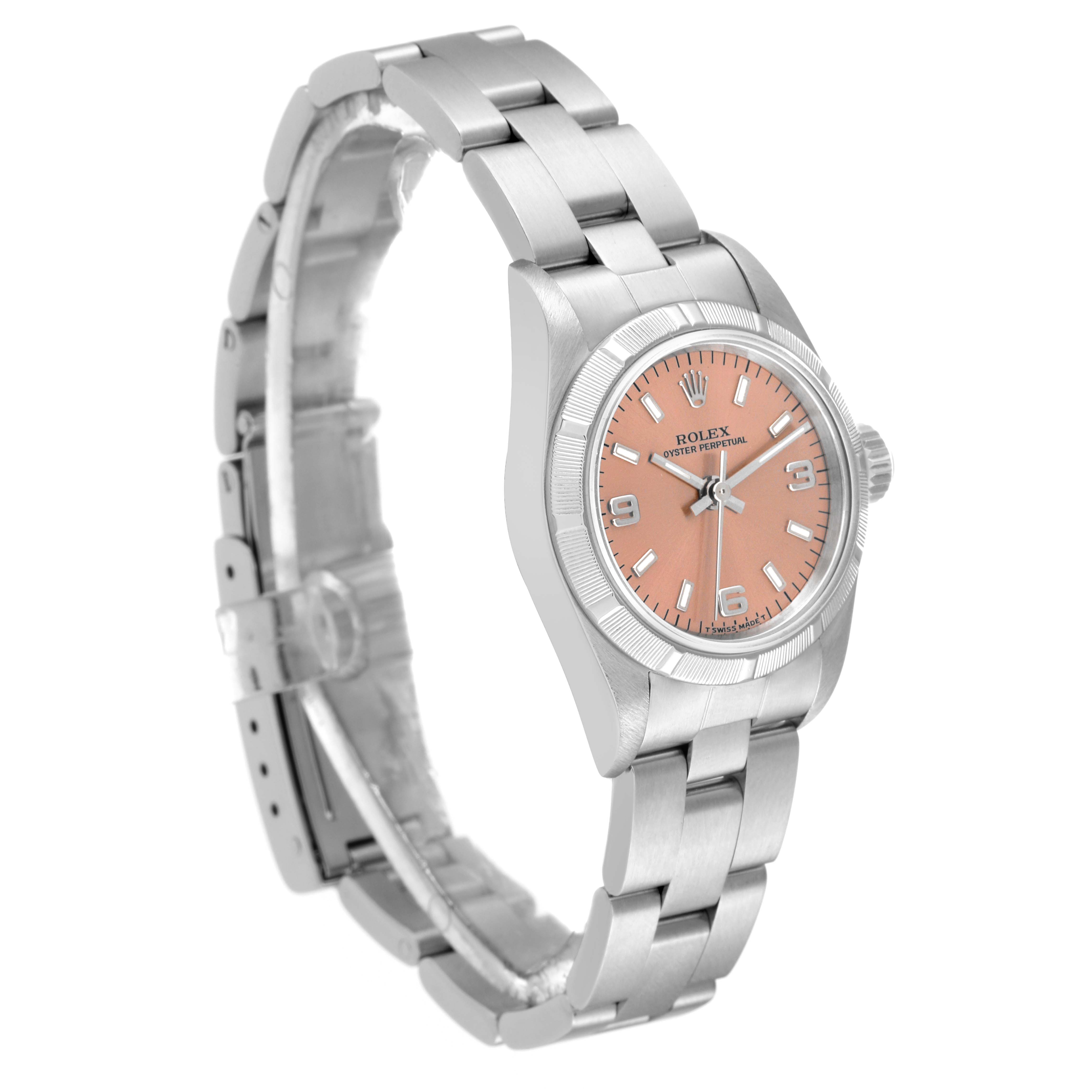 This image shows a Rolex Oyster Perpetual 67230 Women's Stainless Steel Pink Dial 67230 Women's Stainless Steel Pink Dial watch at a slight angle, highlighting the bracelet, bezel, crown, and salmon-colored dial.
