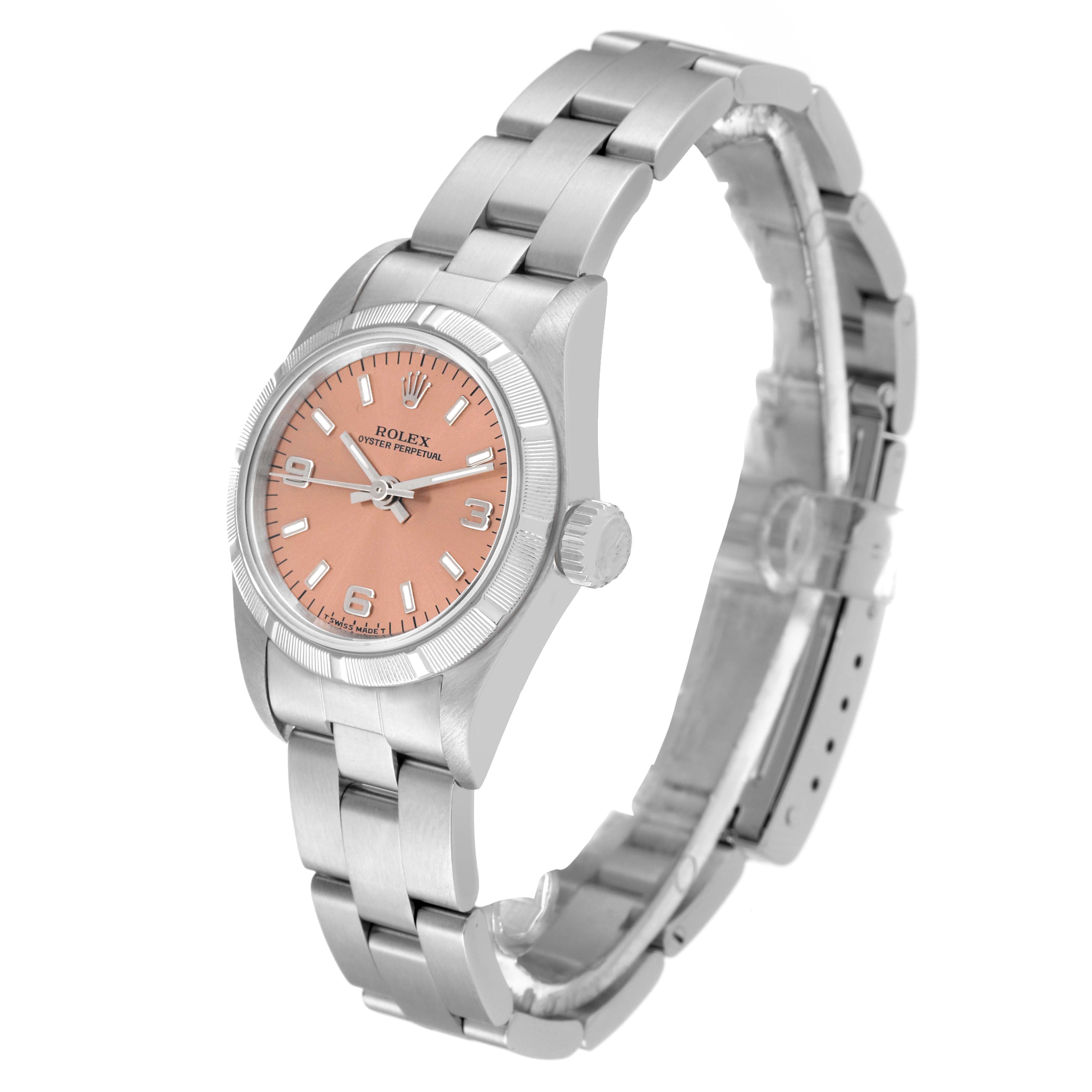 The Rolex Oyster Perpetual 67230 Women's Stainless Steel Pink Dial 67230 Women's Stainless Steel Pink Dial watch is shown at a slight angle, displaying the pink dial, crown, and metal bracelet.