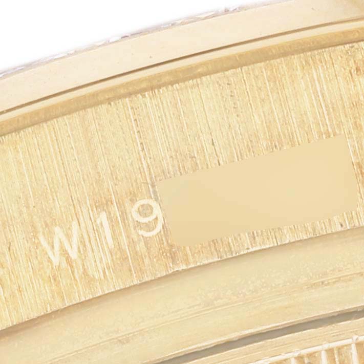 The image shows a close-up of the side engraving on the case of a Rolex Pearlmaster 69298 Women's Yellow Gold Champagne Dial 69298 Women's Yellow Gold Champagne Dial watch.