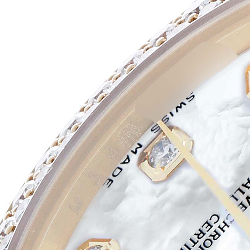 The image shows a close-up of the Rolex Pearlmaster 81338 Women
s Yellow Gold Mother of Pearl Dial watch face and bejeweled bezel, focusing on the dial and one index marker.