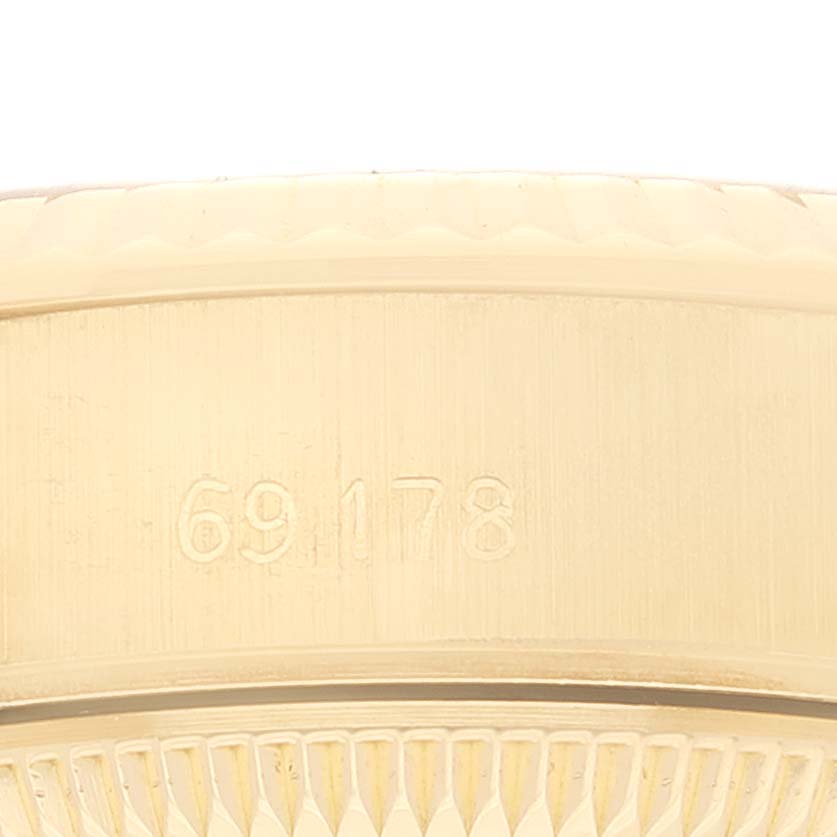 The image shows a close-up of the side of the Rolex President 69178 Women's Yellow Gold Black Dial 69178 Women's Yellow Gold Black Dial model, highlighting its reference number and the textured edge.