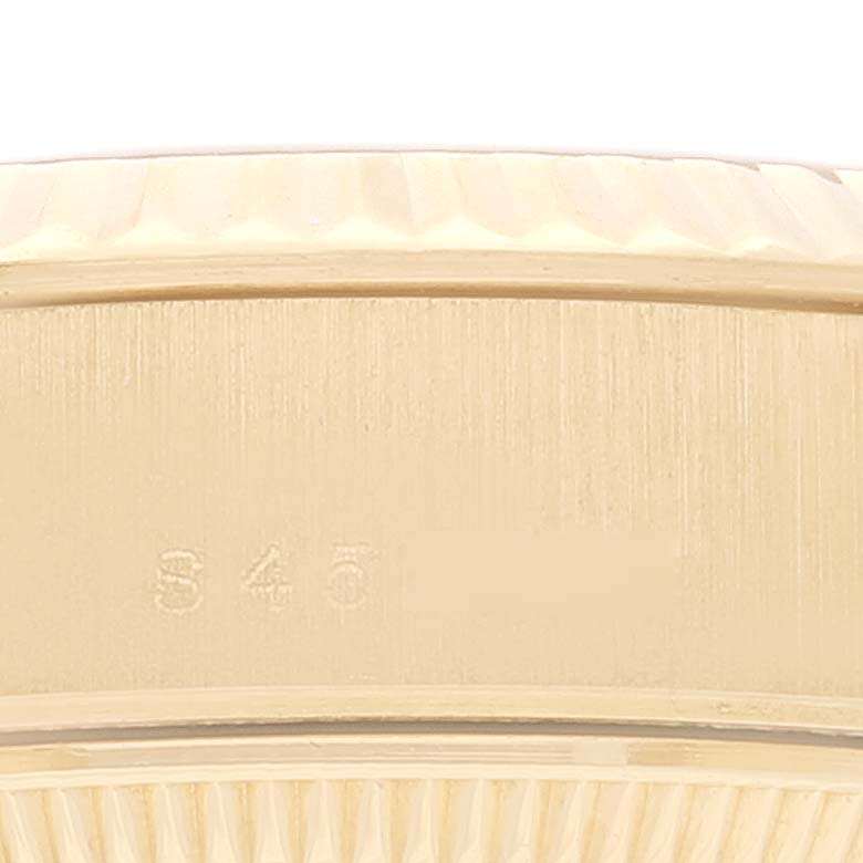 The image shows a close-up of the side of a Rolex President 69178 Women
s Yellow Gold Champagne Dial 69178 Women
s Yellow Gold Champagne Dial watch, highlighting the engraved serial number and the case edge.