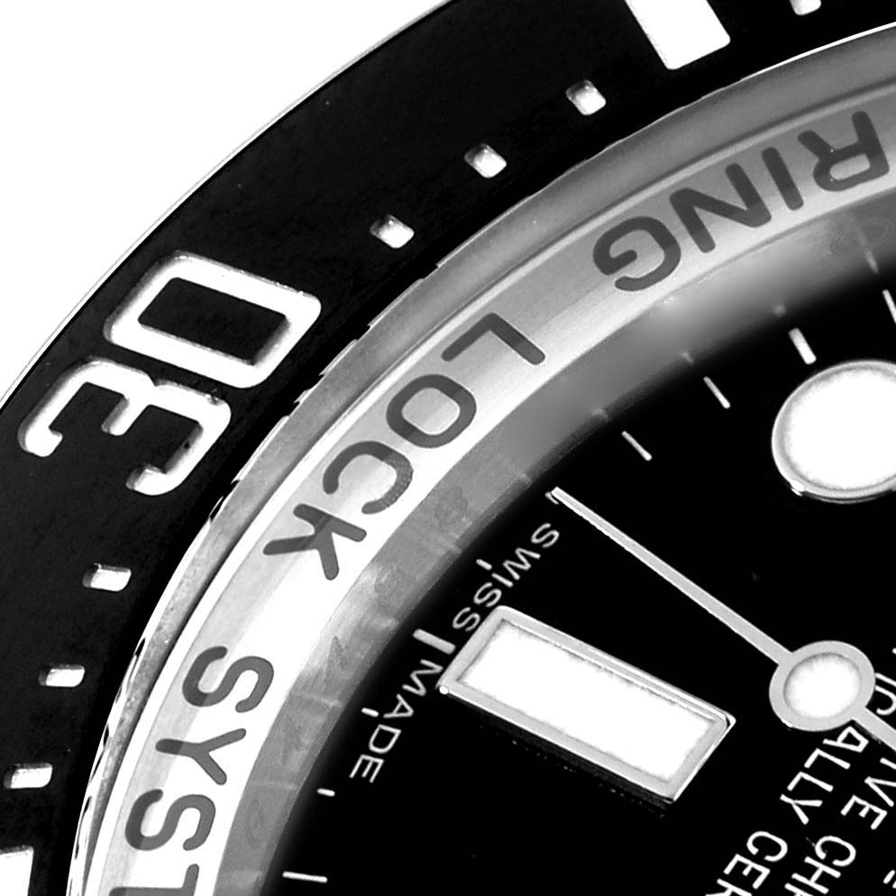 The image shows a close-up of the bezel and part of the dial of a Rolex Sea-Dweller 116660 Men's Stainless Steel Black Dial 116660 Men's Stainless Steel Black Dial watch.
