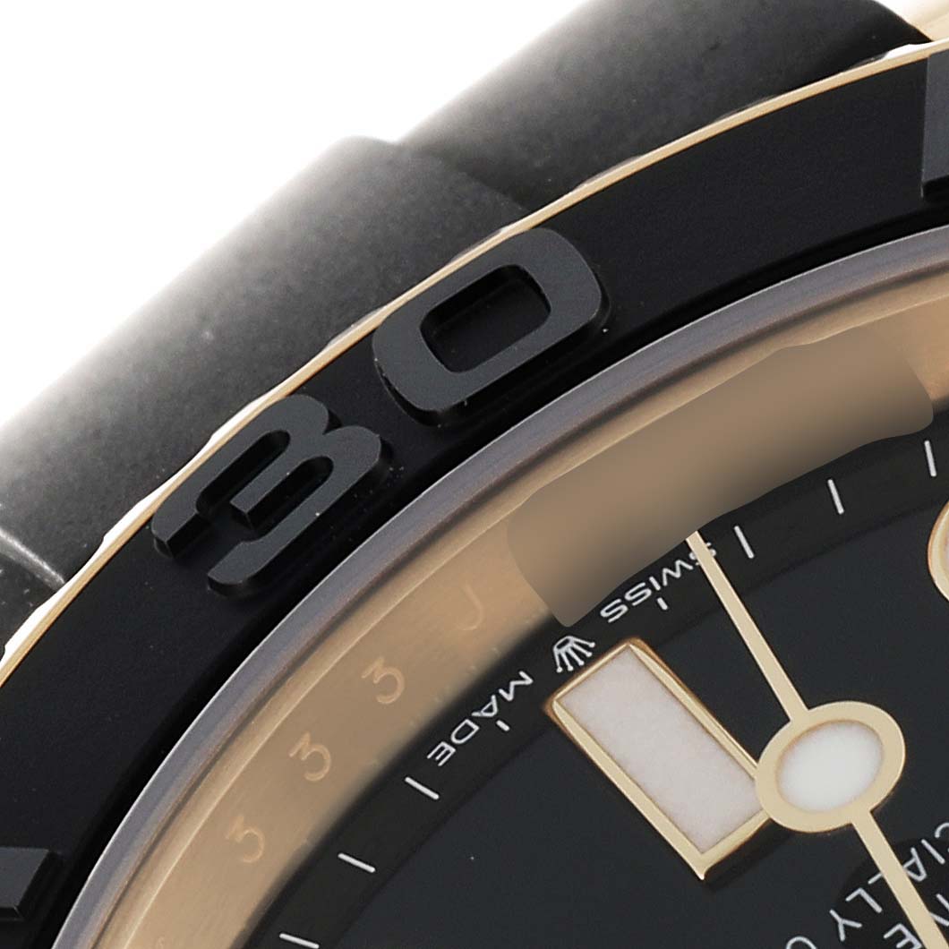 This close-up angle shows part of the bezel, dial, and strap of the Rolex Yacht-Master 226658 Men's Yellow Gold Black Dial 226658 Men's Yellow Gold Black Dial watch.