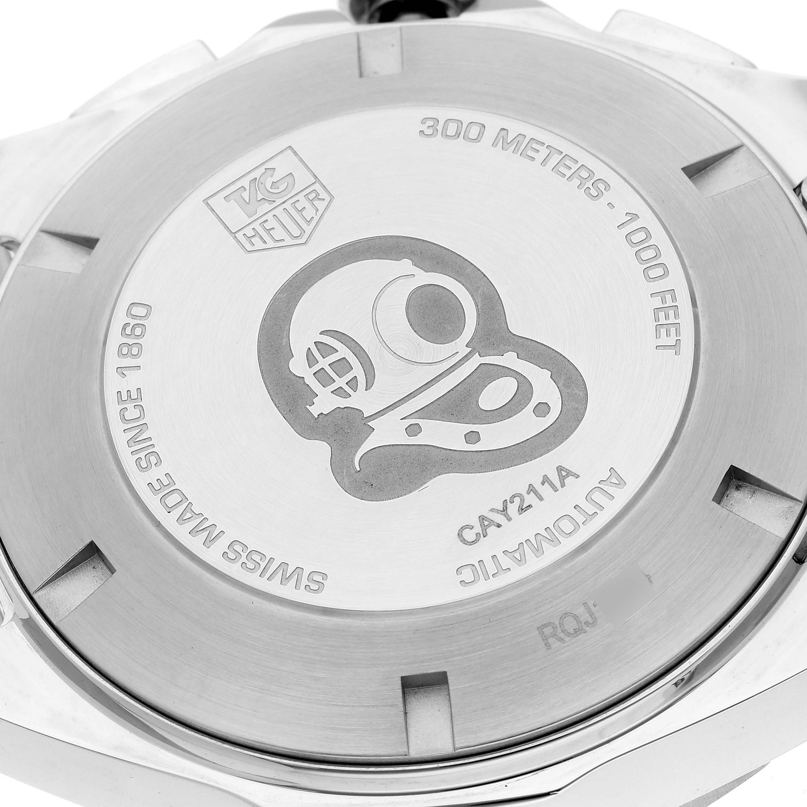 The image shows the case back of the Tag Heuer Aquaracer CAY211A Men's Stainless Steel Black Dial CAY211A Men's Stainless Steel Black Dial watch, featuring etched text and a diving helmet design.