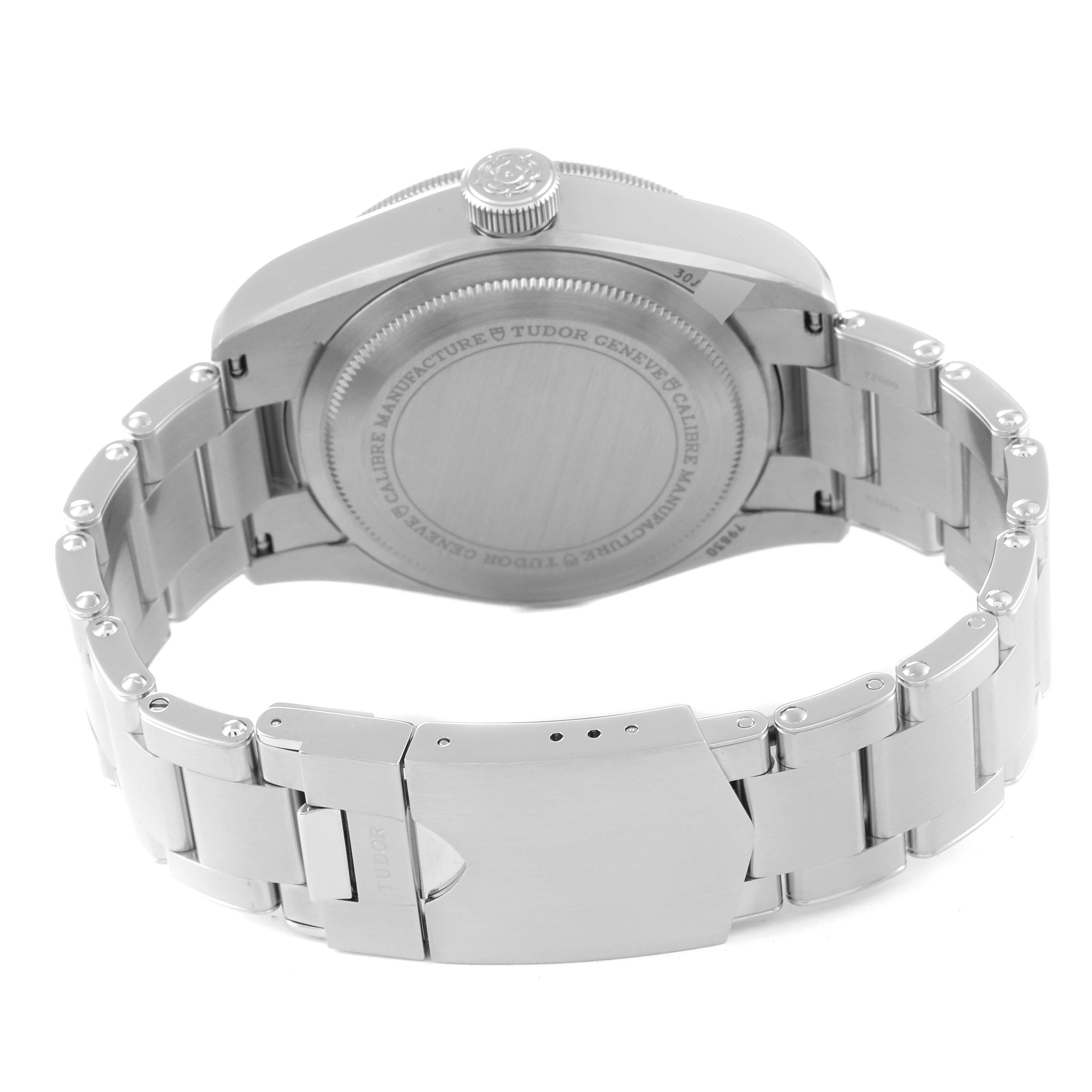 The image shows the backside of the Tudor Heritage Black Bay 79830RB Men
s Stainless Steel Black Dial 79830RB Men
s Stainless Steel Black Dial watch, highlighting its case back, crown, and bracelet with clasp.