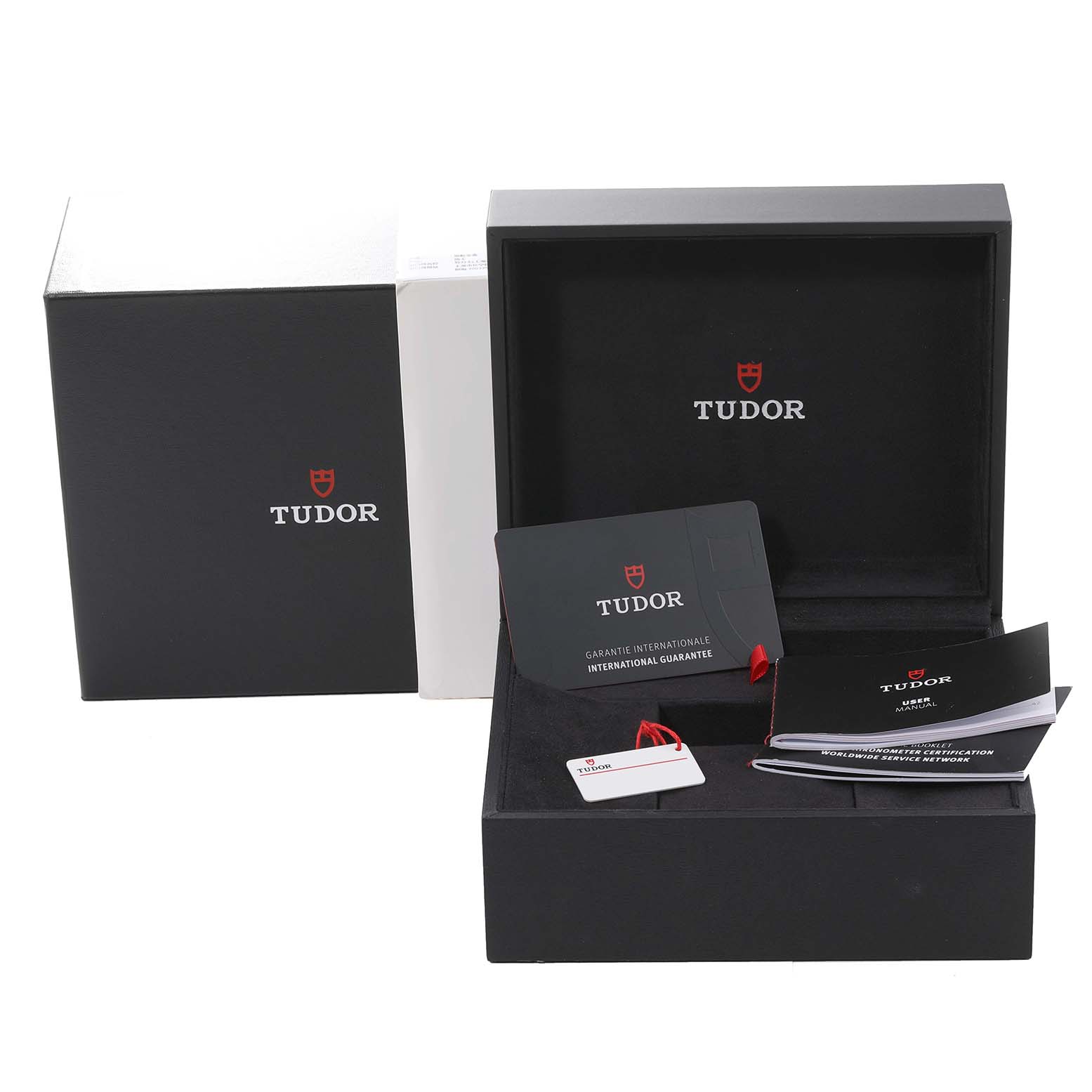 This image shows the packaging and accessories of the Tudor Heritage Black Bay 79830RB Men
s Stainless Steel Black Dial 79830RB Men
s Stainless Steel Black Dial watch, including the box, manuals, and warranty card.