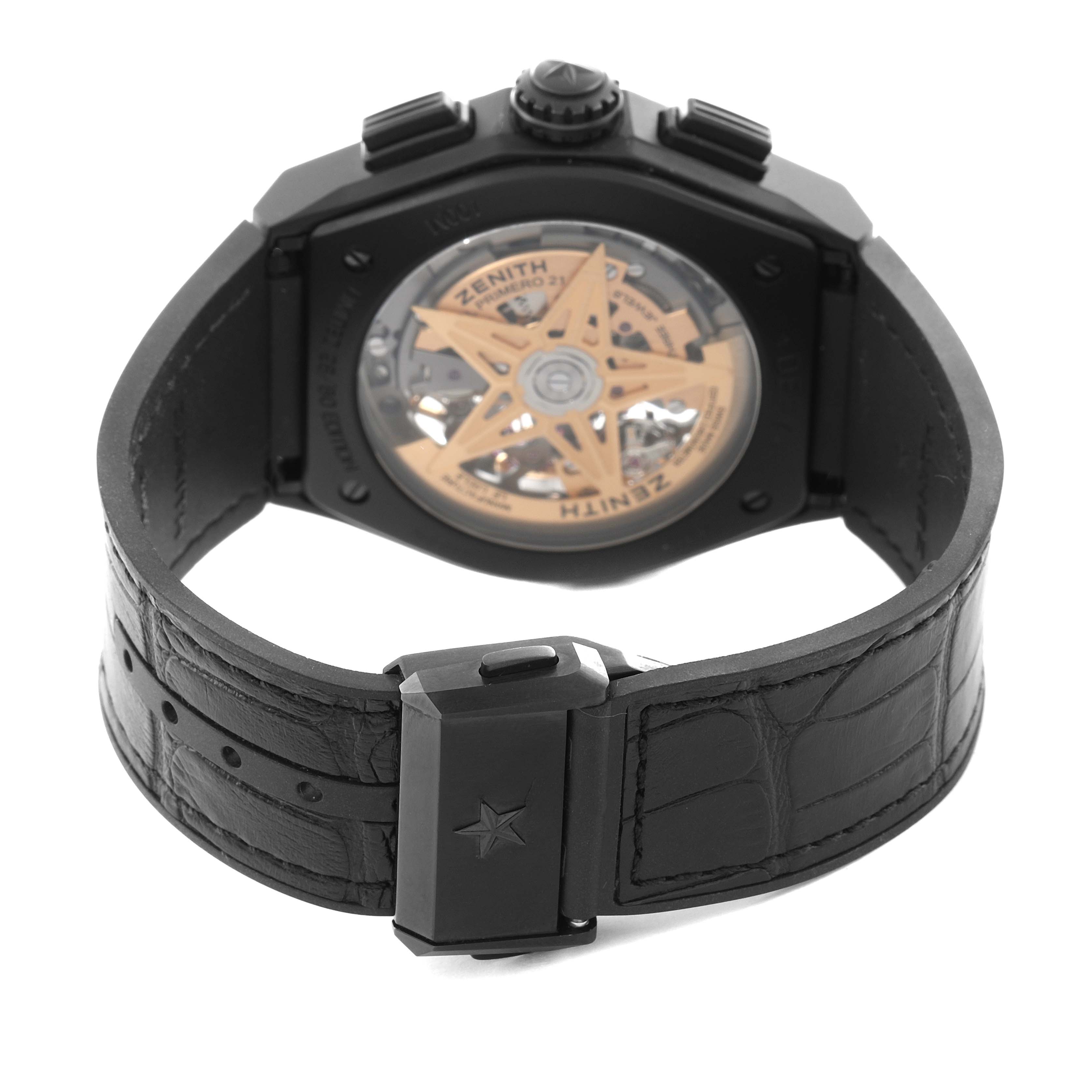 The image shows the back view of the Zenith El Primero 49.9005.9004/72.R582 Men
s Ceramic Black Dial watch, revealing its movement and black leather strap with a clasp.