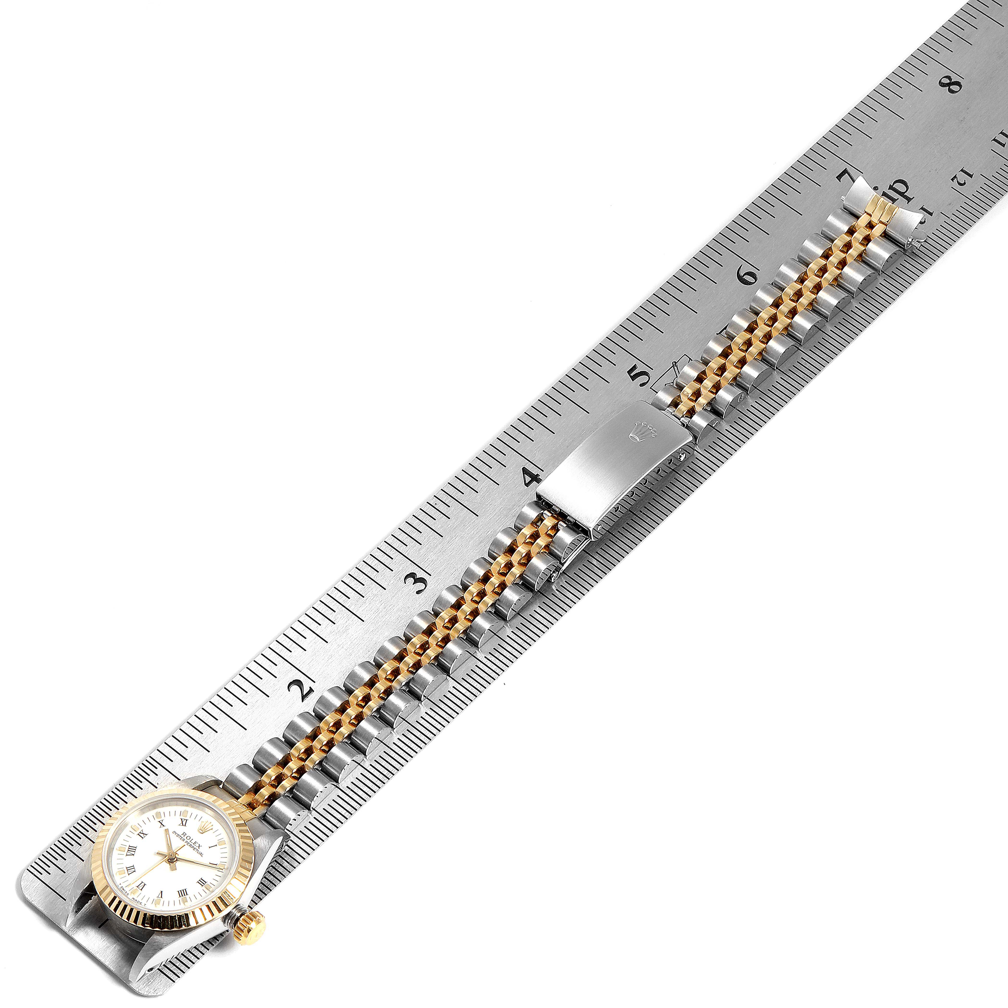 The image shows a Rolex Datejust 67193 Women
s Steel and Gold (two tone) White Dial 67193 Women
s Steel and Gold (two tone) White Dial watch laid flat with a ruler measuring its length, displaying the dial, crown, and two-tone bracelet.