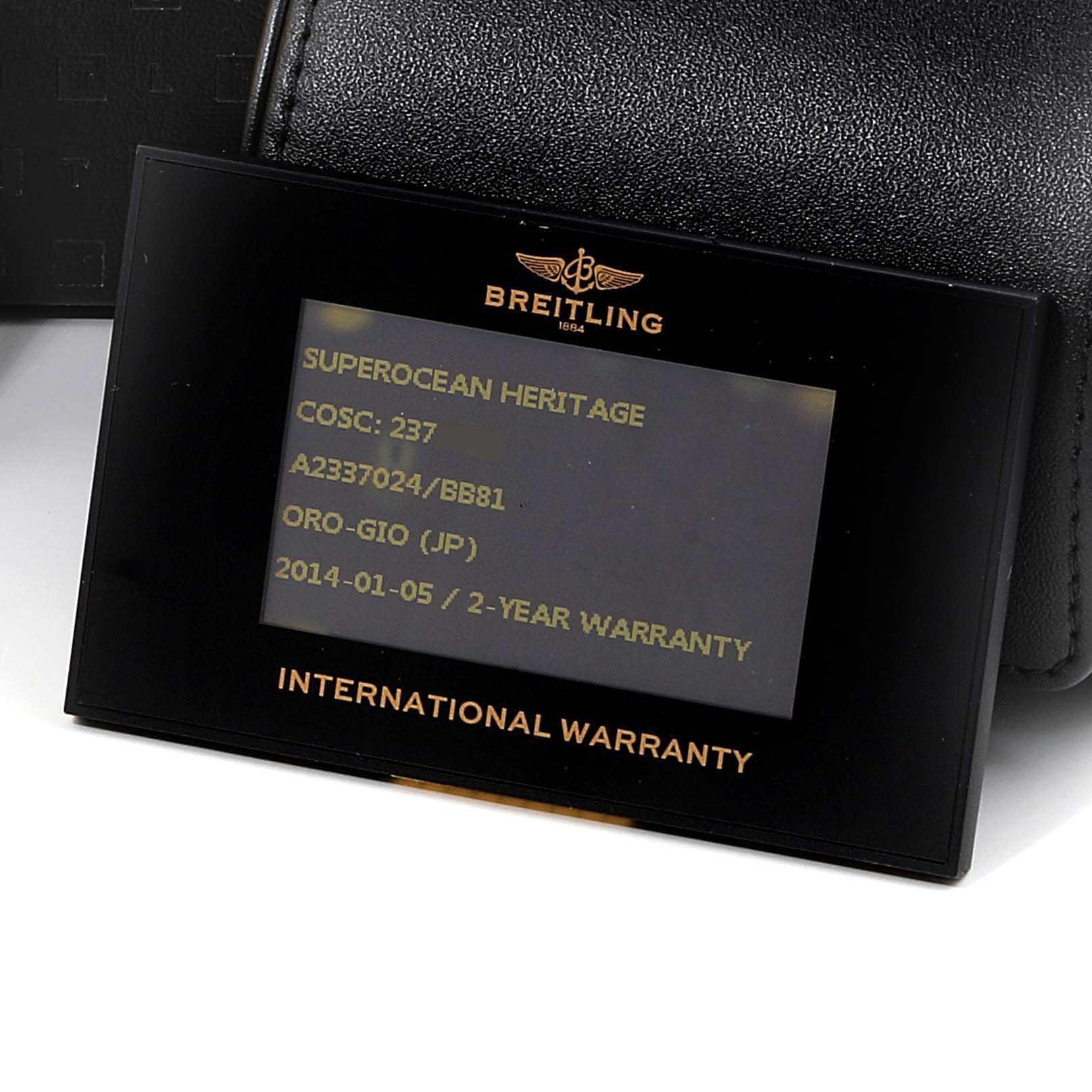 The image shows an international warranty card for the Breitling Superocean A23370 Men's Stainless Steel Black Dial A23370 Men's Stainless Steel Black Dial Heritage model, with a black leather case in the background.