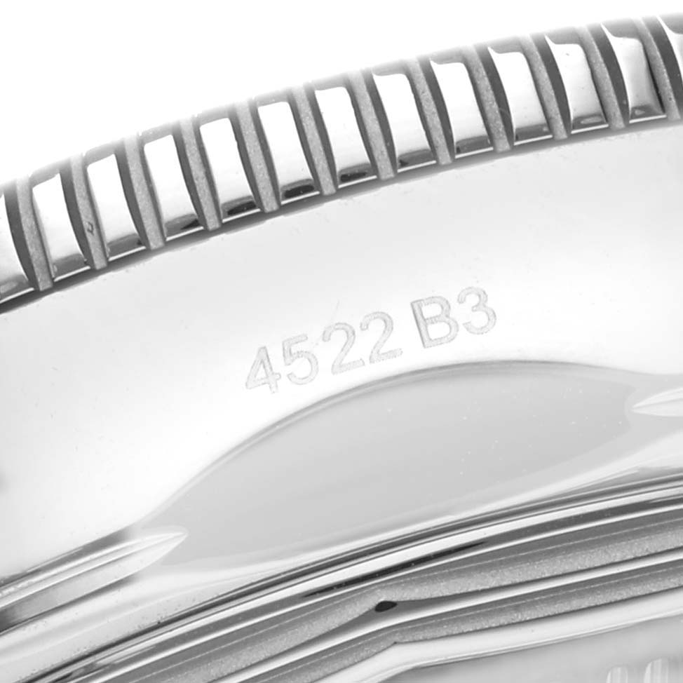 This image shows a close-up of the engraved side of the Breitling Superocean AB2010 Men
s Stainless Steel Black Dial AB2010 Men
s Stainless Steel Black Dial watch, focusing on part of the bezel and case back.