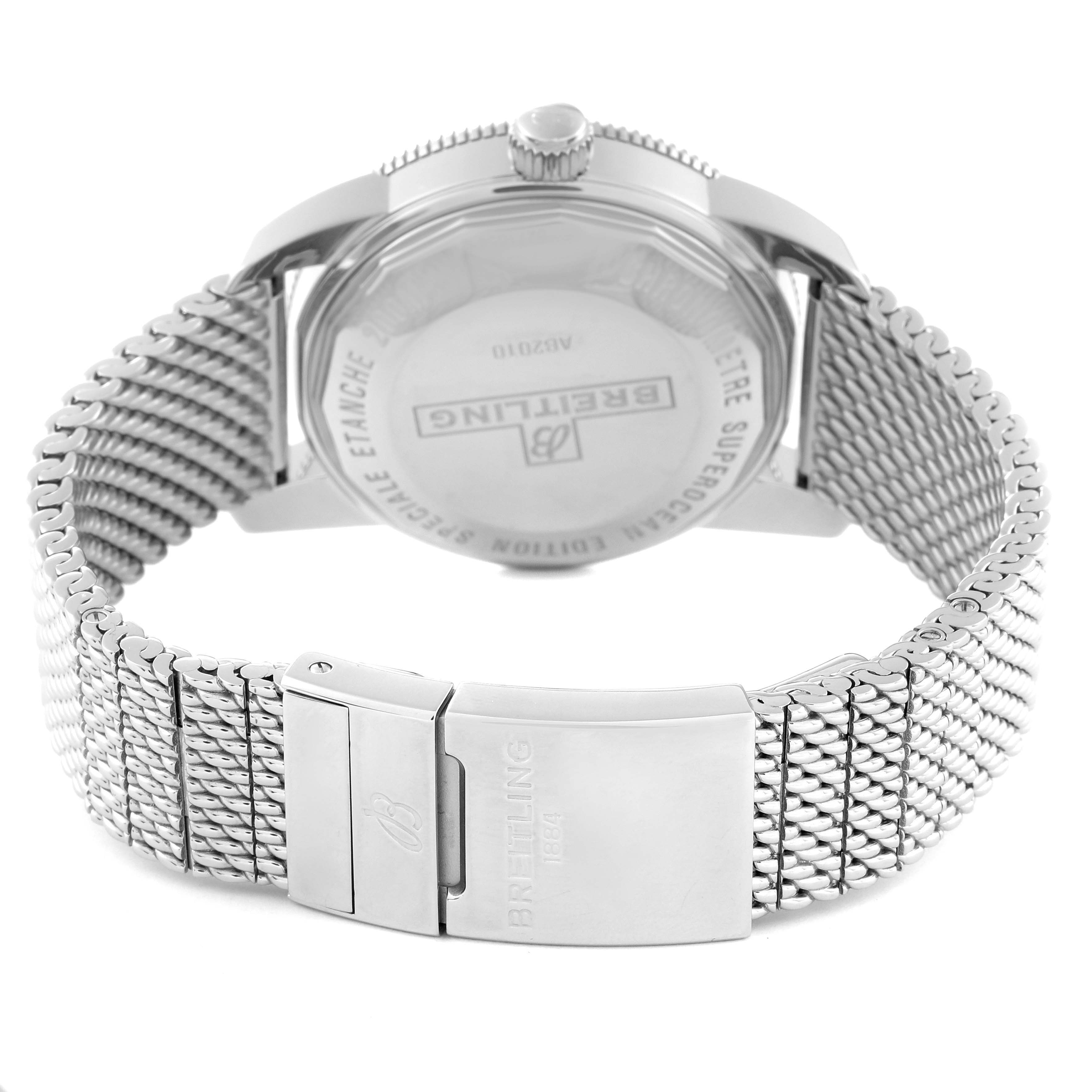 This image shows the back angle of a Breitling Superocean AB2010 Men
s Stainless Steel Black Dial AB2010 Men
s Stainless Steel Black Dial watch, featuring its case back, crown, and metal mesh bracelet with a clasp.