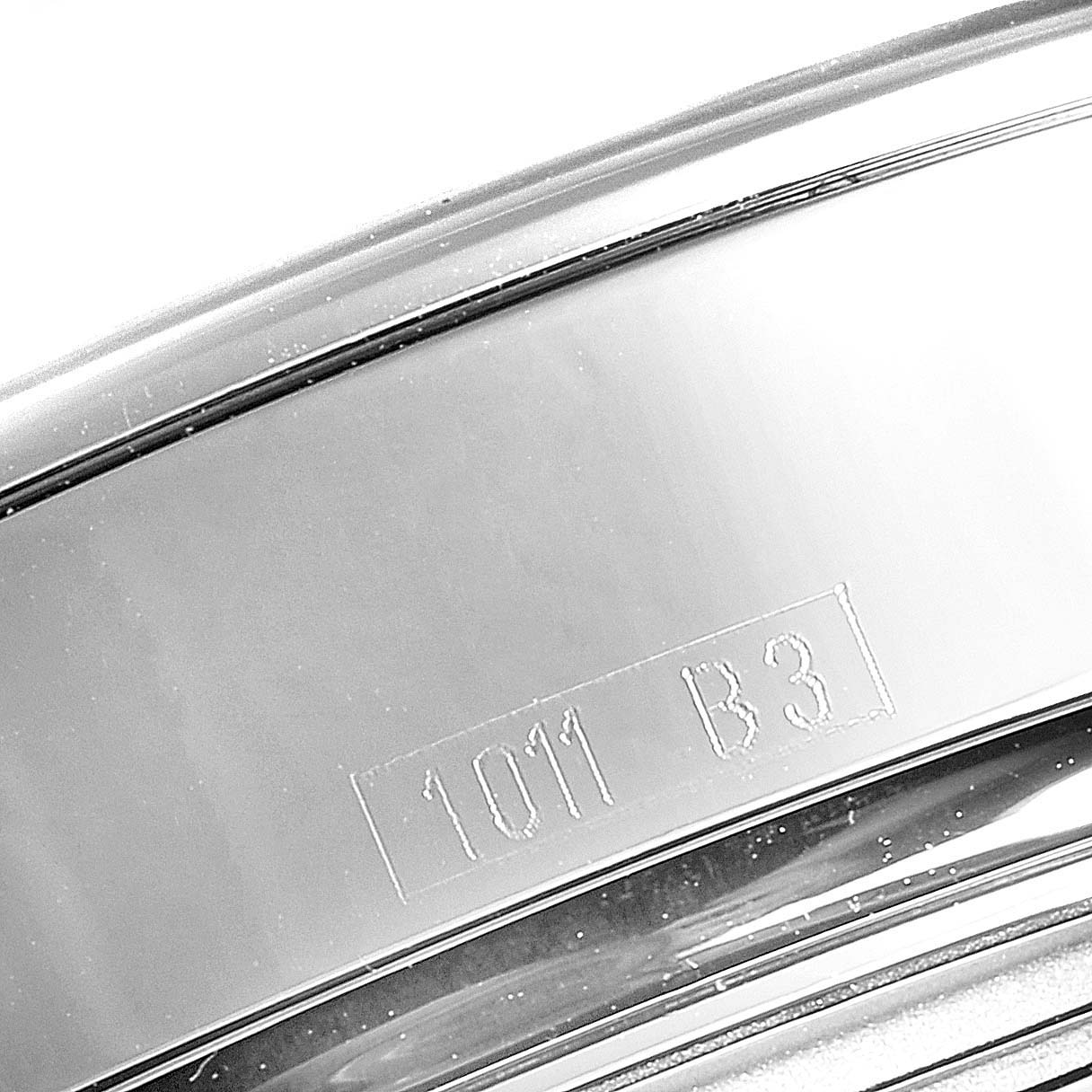 This image shows a close-up of the stainless steel band of the Breitling Transocean AB0151 Men's Stainless Steel Black Dial AB0151 Men's Stainless Steel Black Dial watch with the engraving "1011 B3."