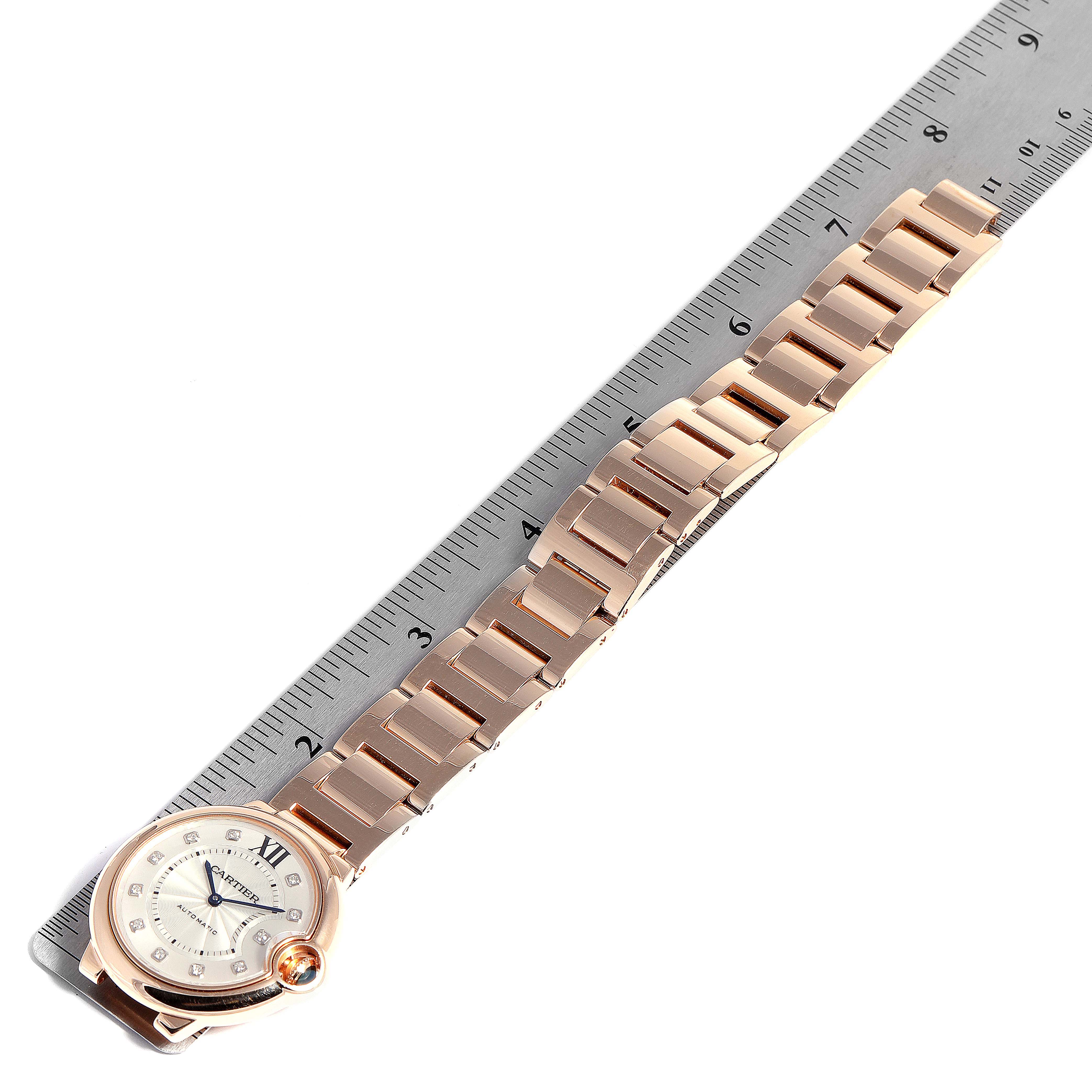 This image shows a rose gold bracelet and round face of the Ballon Bleu model by Cartier, with a ruler indicating length.