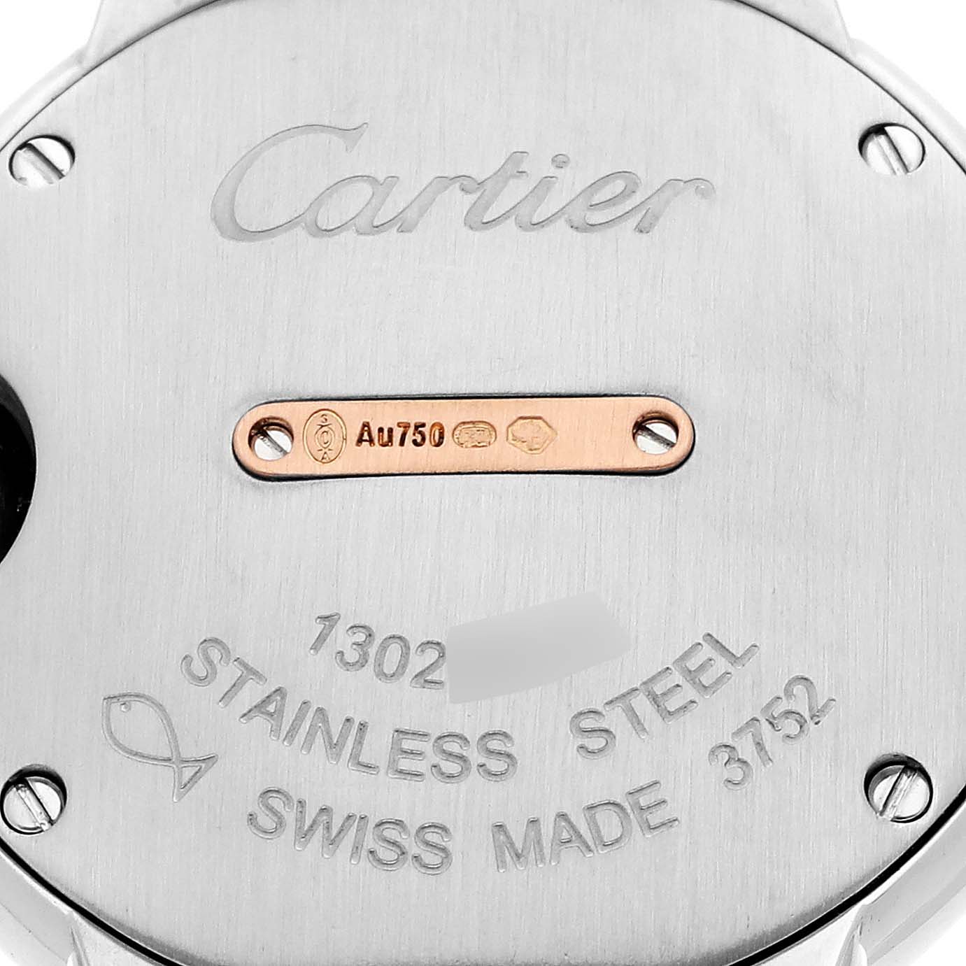 This is a close-up shot of the back of a Cartier Ballon Bleu W3BB0009 Women's Steel and Gold (two tone) Silver Dial W3BB0009 Women's Steel and Gold (two tone) Silver Dial watch, showing the brand engraving, material stamps, and serial number.