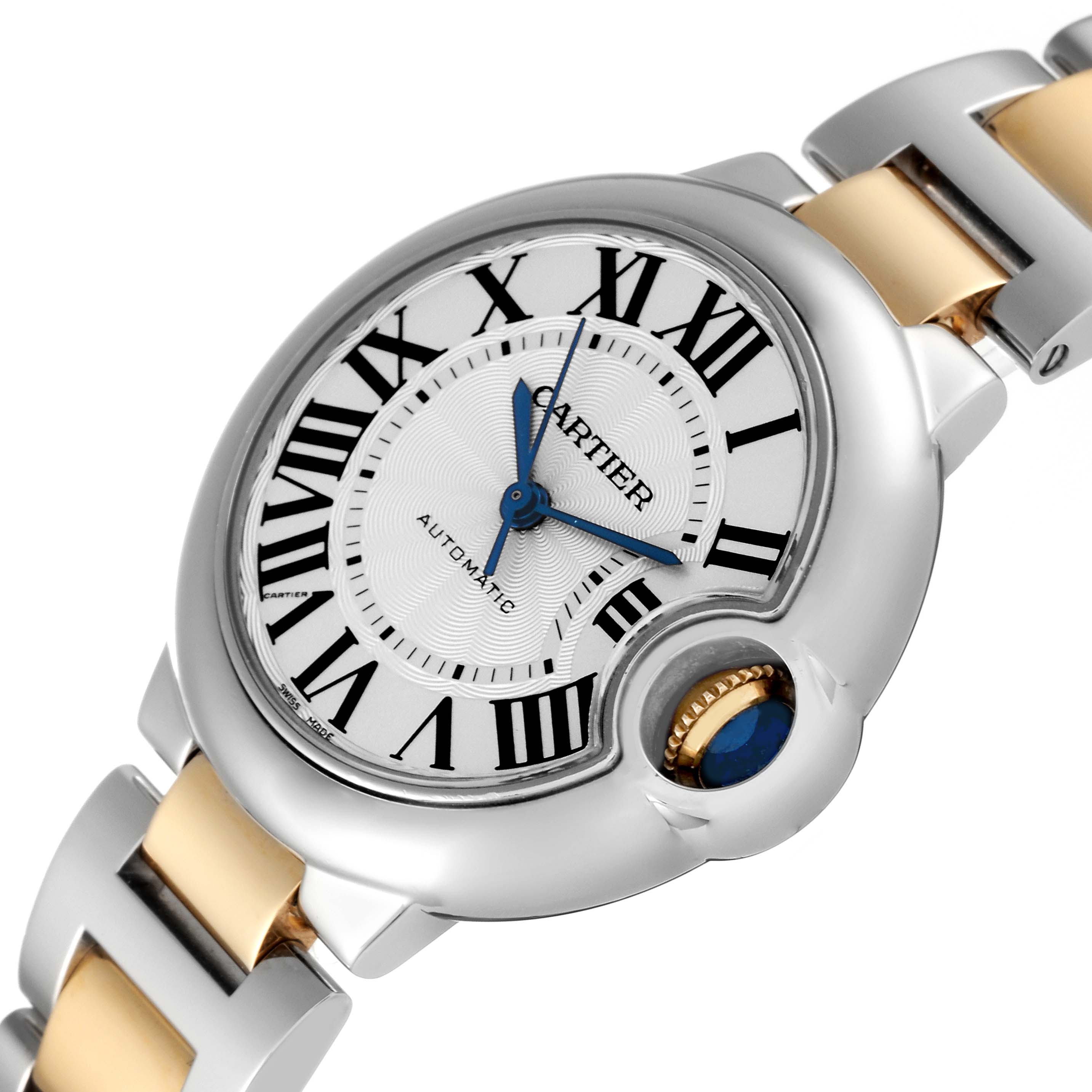 The image shows a close-up angle of the dial, crown, and a part of the bracelet of the Cartier Ballon Bleu W2BB0002 Women's Stainless Steel Silver Dial W2BB0002 Women's Stainless Steel Silver Dial watch.