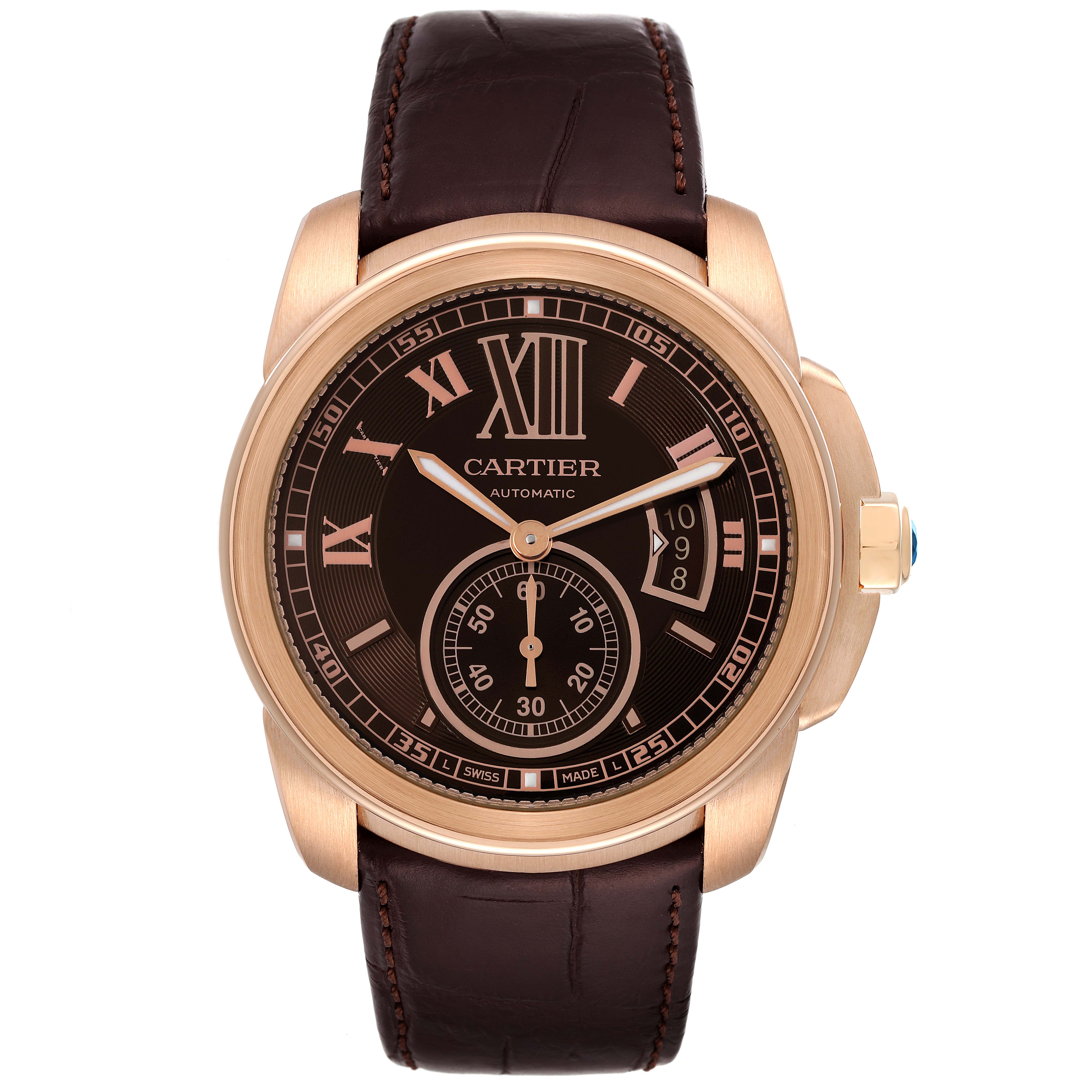 The image shows a frontal view of the Calibre de Cartier watch by Cartier, highlighting its dial, hands, and leather strap.