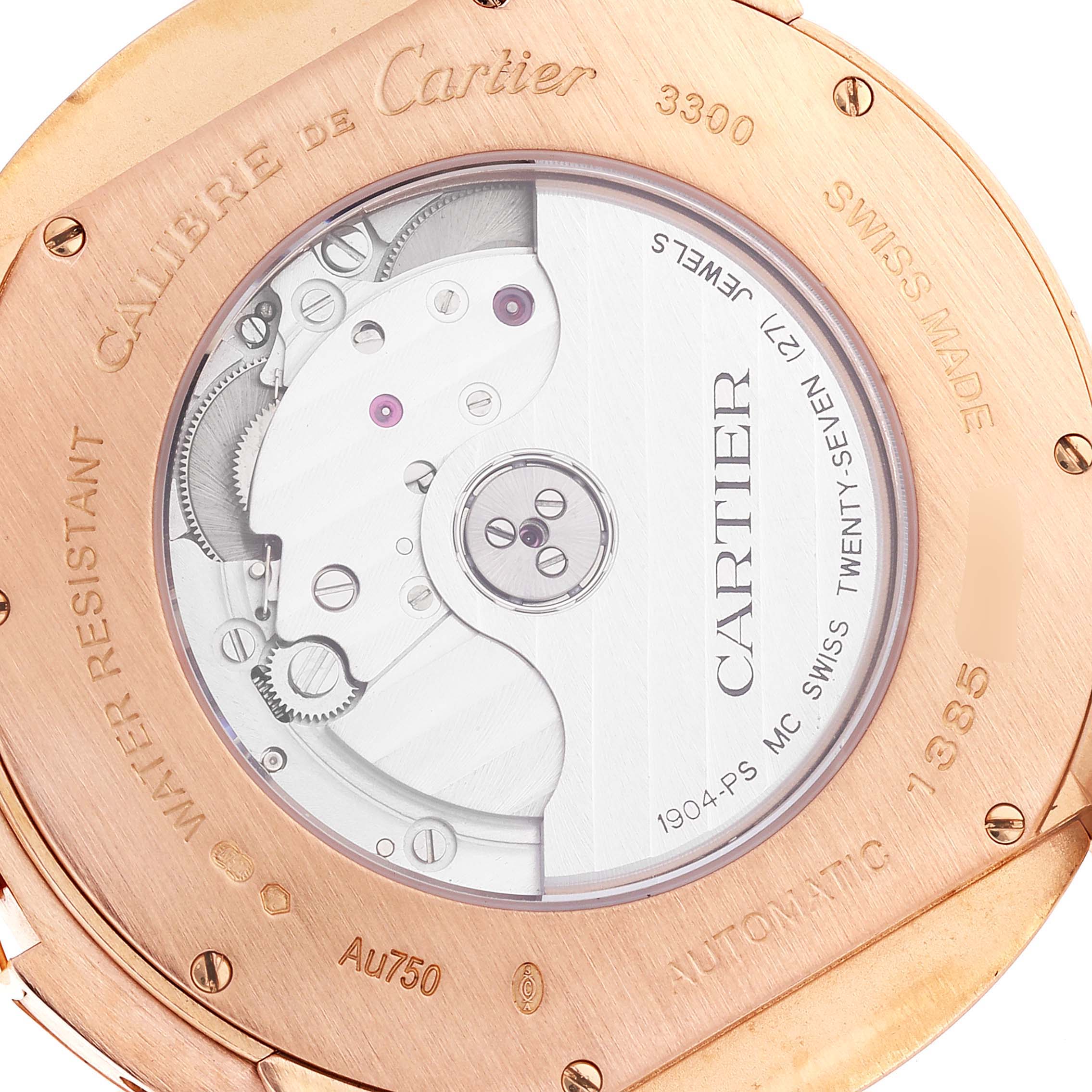 The image shows the back of a Calibre de Cartier watch by Cartier, highlighting its internal mechanism and engraved details.