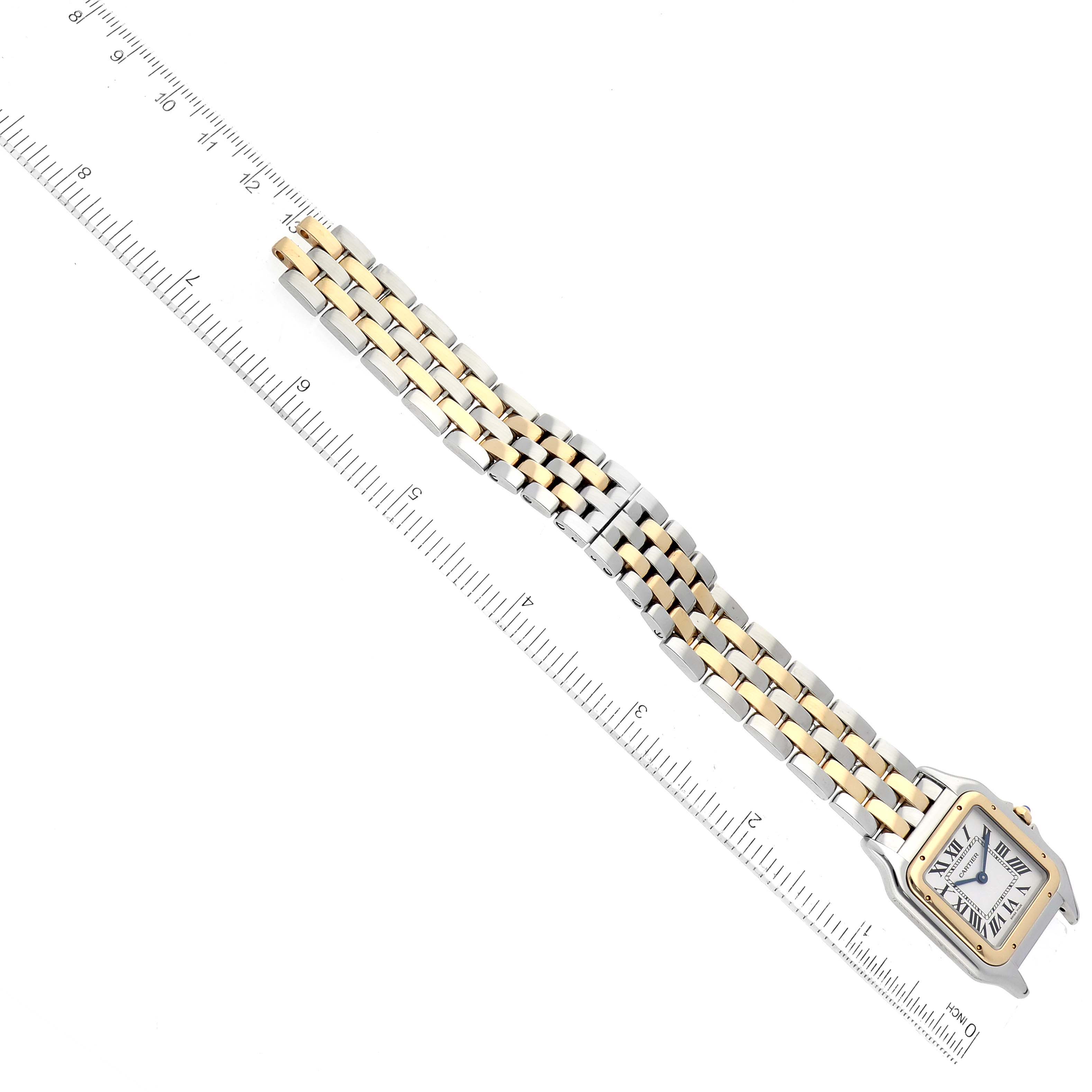 The image shows a Panthere model watch by Cartier in a tilted angle, highlighting the face and two-tone metal bracelet alongside a ruler.