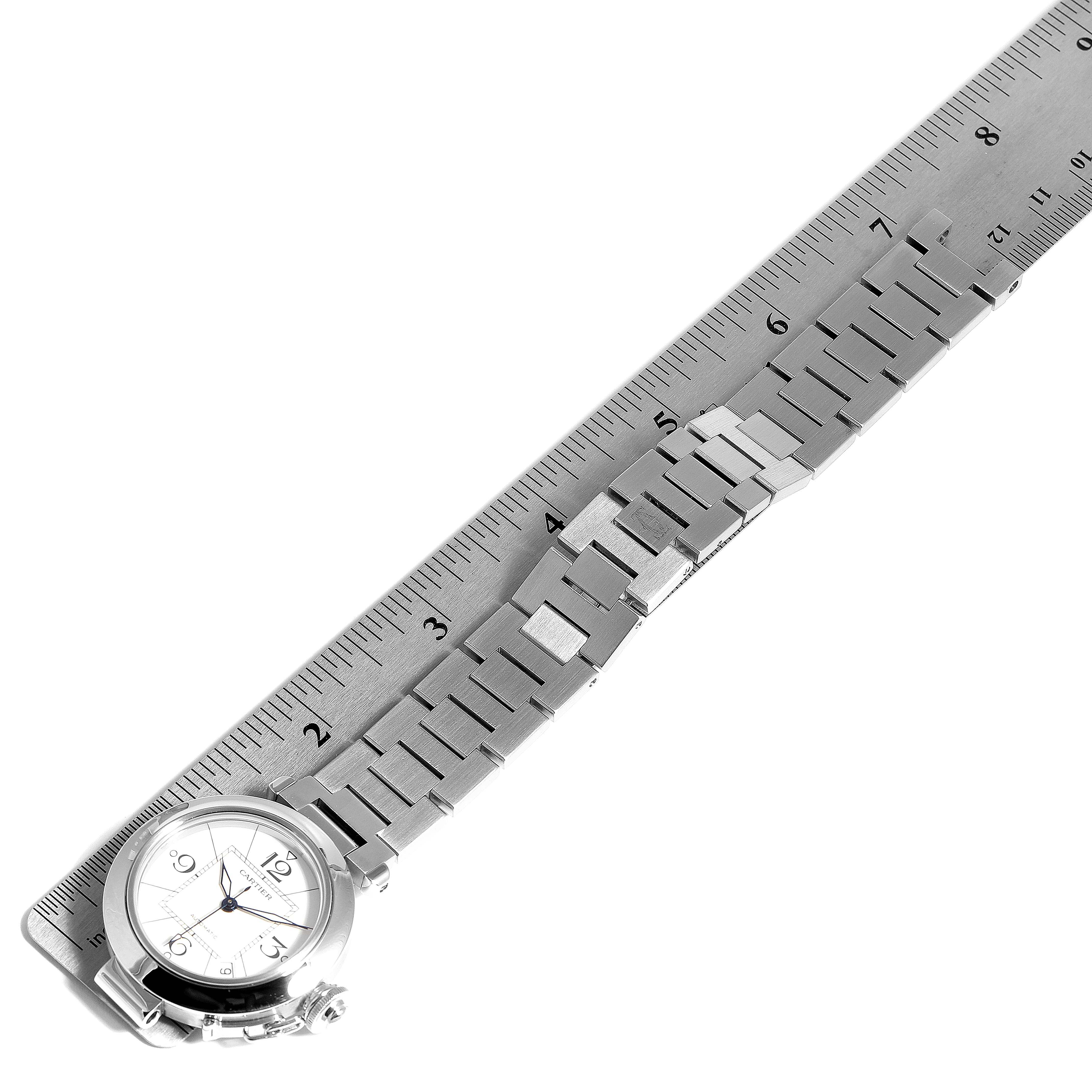 The image shows a Cartier Pasha W31074M7 Men's Stainless Steel White Dial W31074M7 Men's Stainless Steel White Dial watch laid flat with a ruler measuring its stainless steel bracelet.