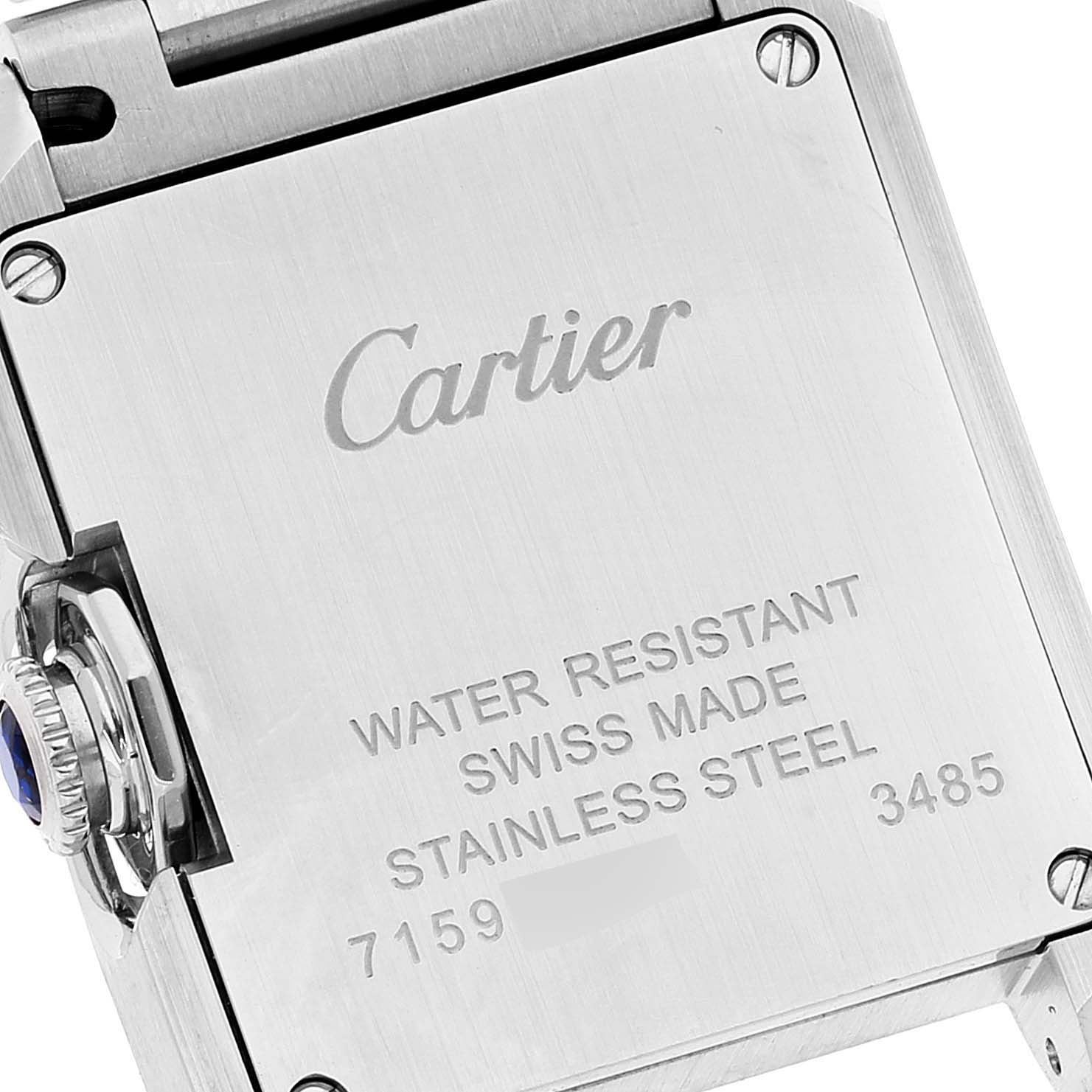The image shows the back case of a Cartier Tank Anglaise W5310022 Women
s Stainless Steel Silver Dial W5310022 Women
s Stainless Steel Silver Dial watch, highlighting its water resistance, stainless steel material, and serial numbers.