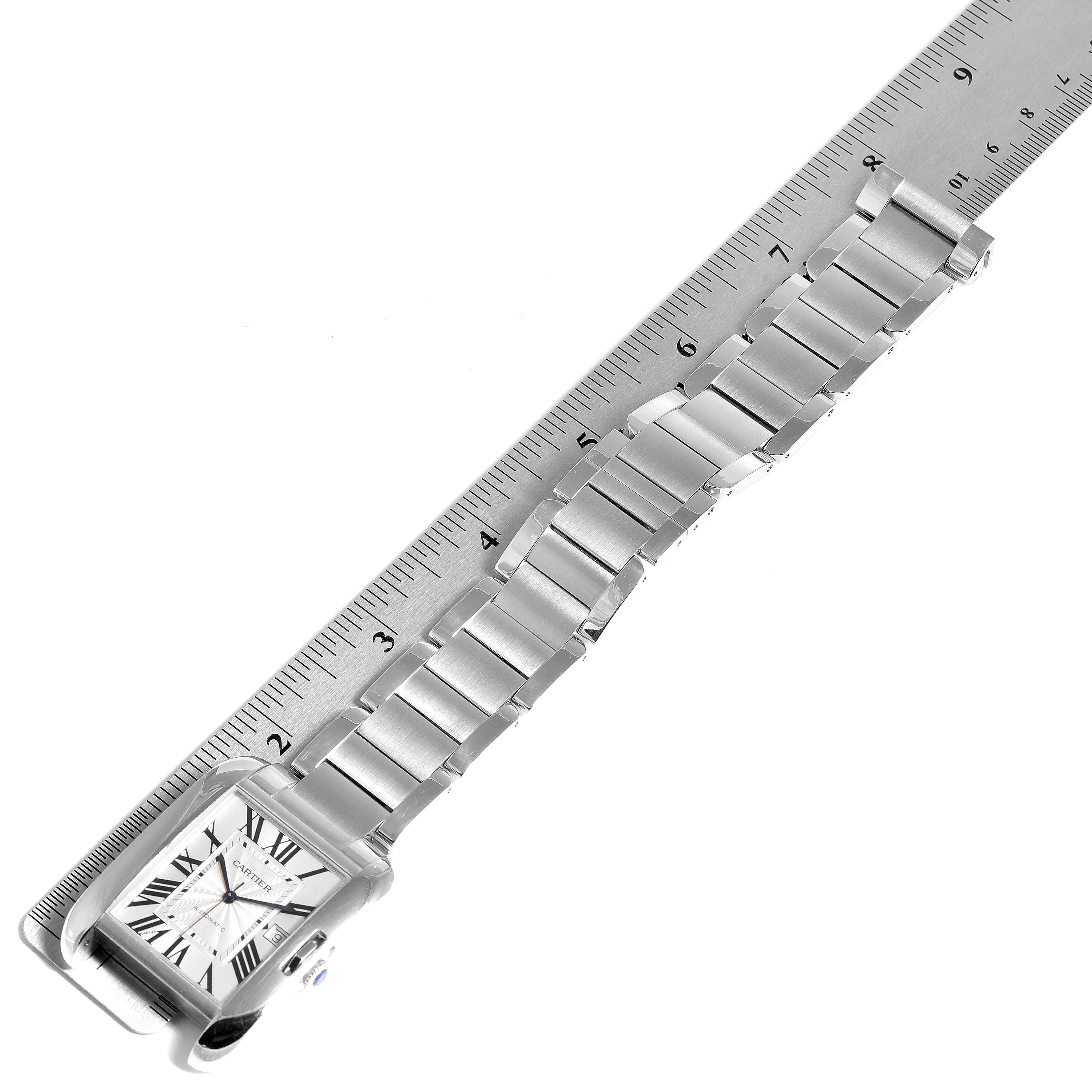 The image shows a Cartier Tank Anglaise W5310008 Men's Stainless Steel Silver Dial W5310008 Men's Stainless Steel Silver Dial watch laid flat alongside a ruler, highlighting the bracelet and face.