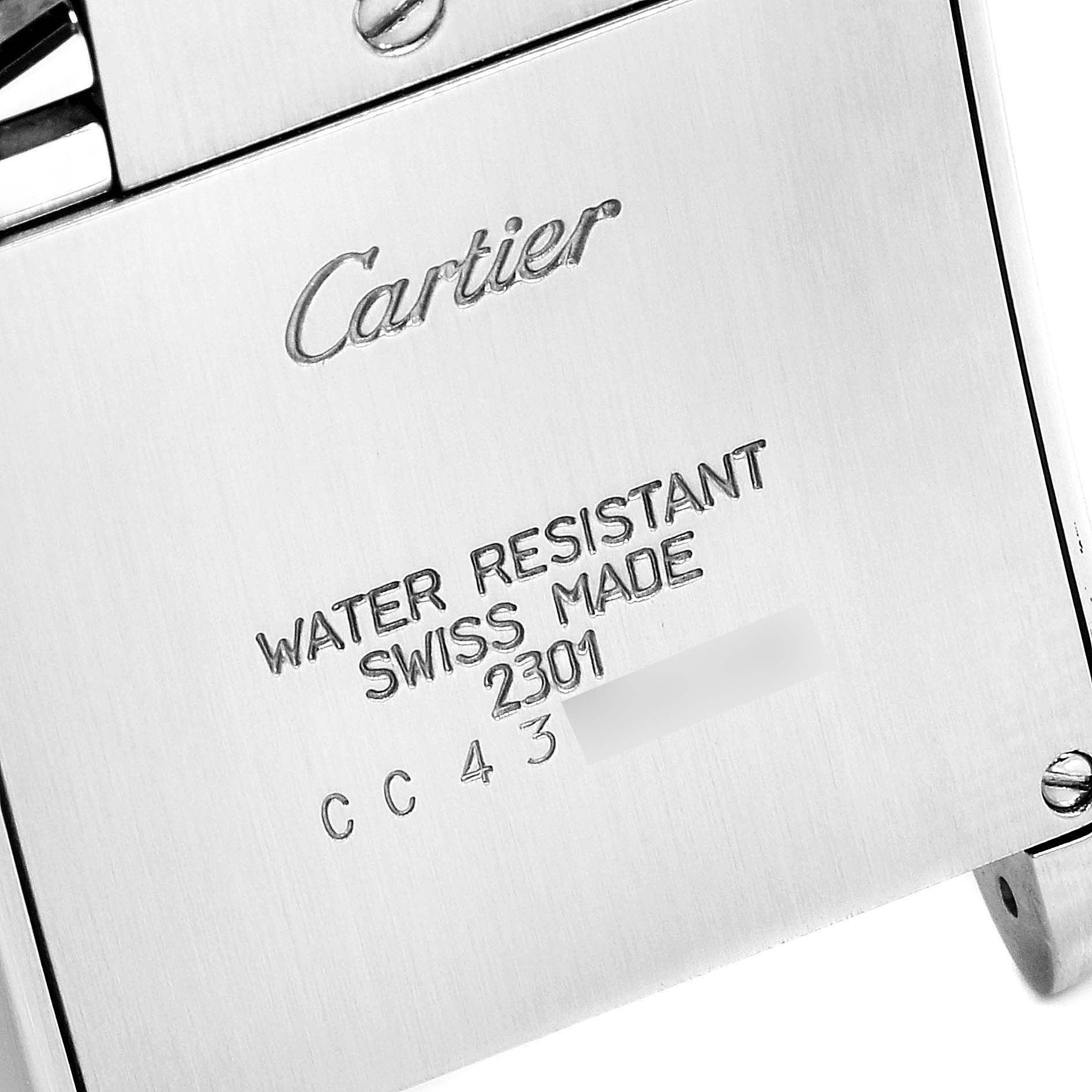 This is a close-up of the back case of a Tank Française watch by Cartier, showing model details and "Swiss Made" inscription.