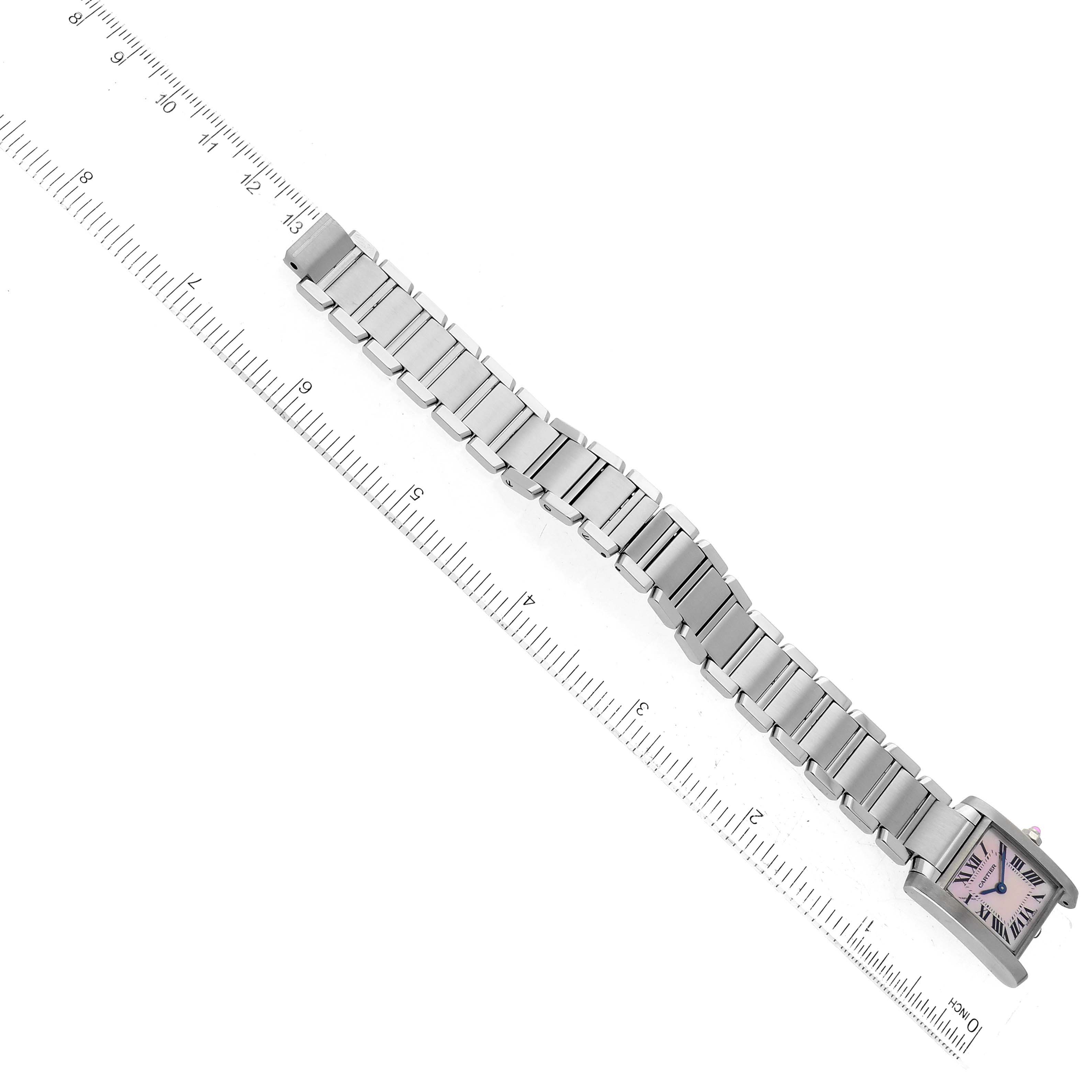 This image shows the top view of a Cartier Tank Française watch, highlighting the watch face, metal bracelet, and its full length measured against a ruler.